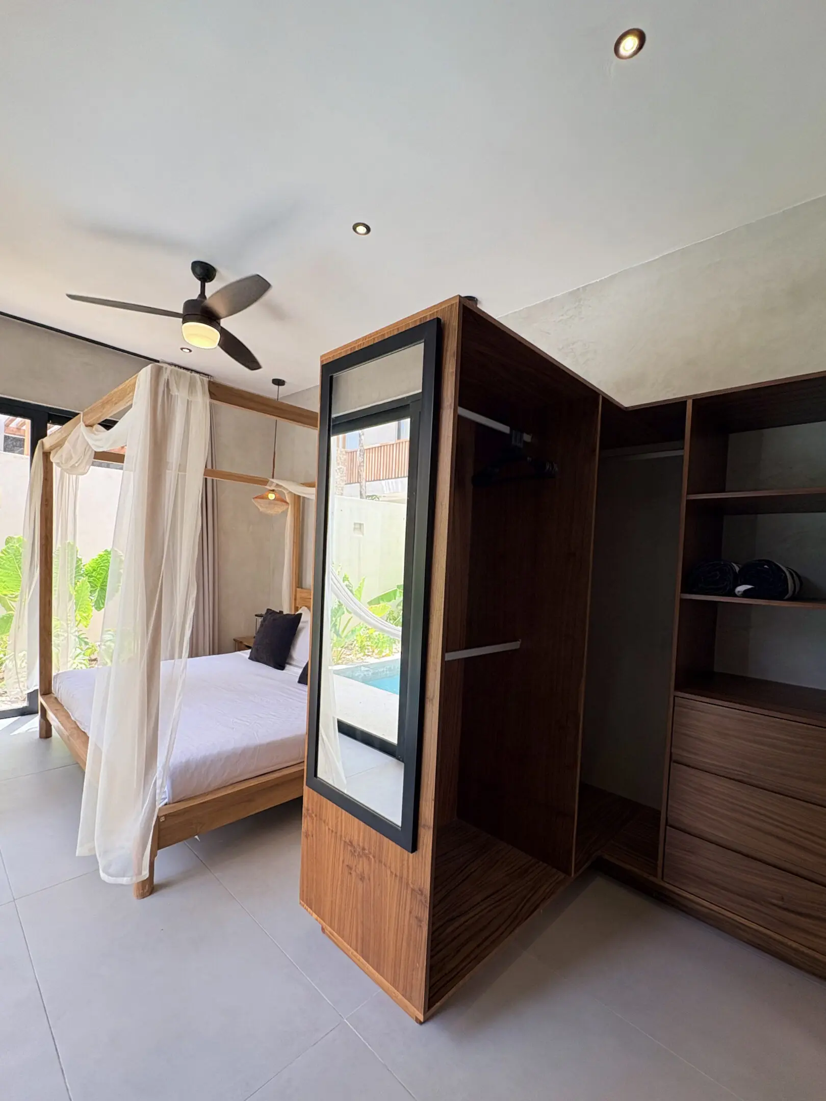 Modern bedroom with canopy bed and mirror wardrobe