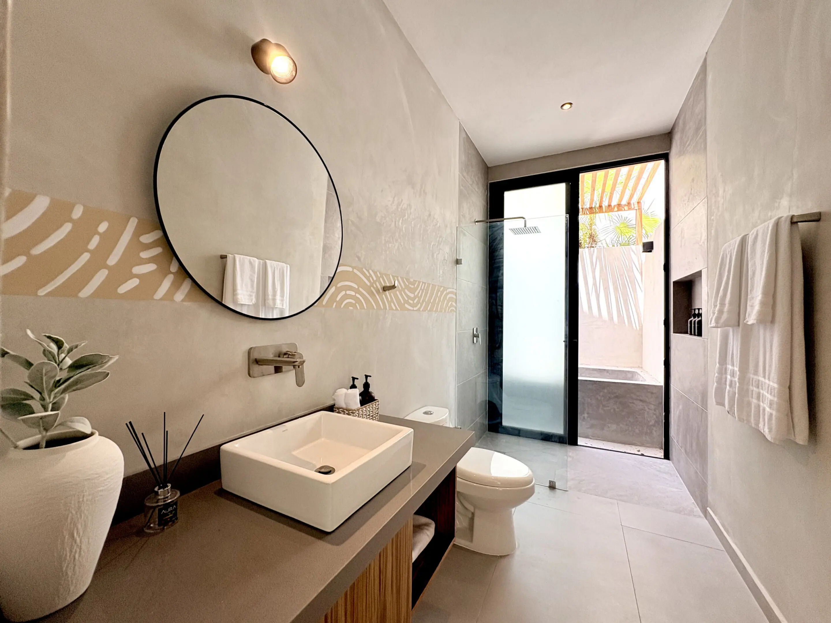 Modern minimalist bathroom with round mirror