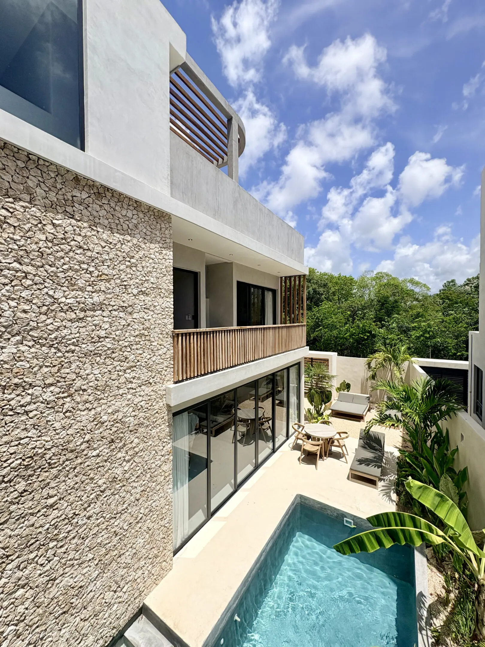Modern villa terrace with pool and tropical plants