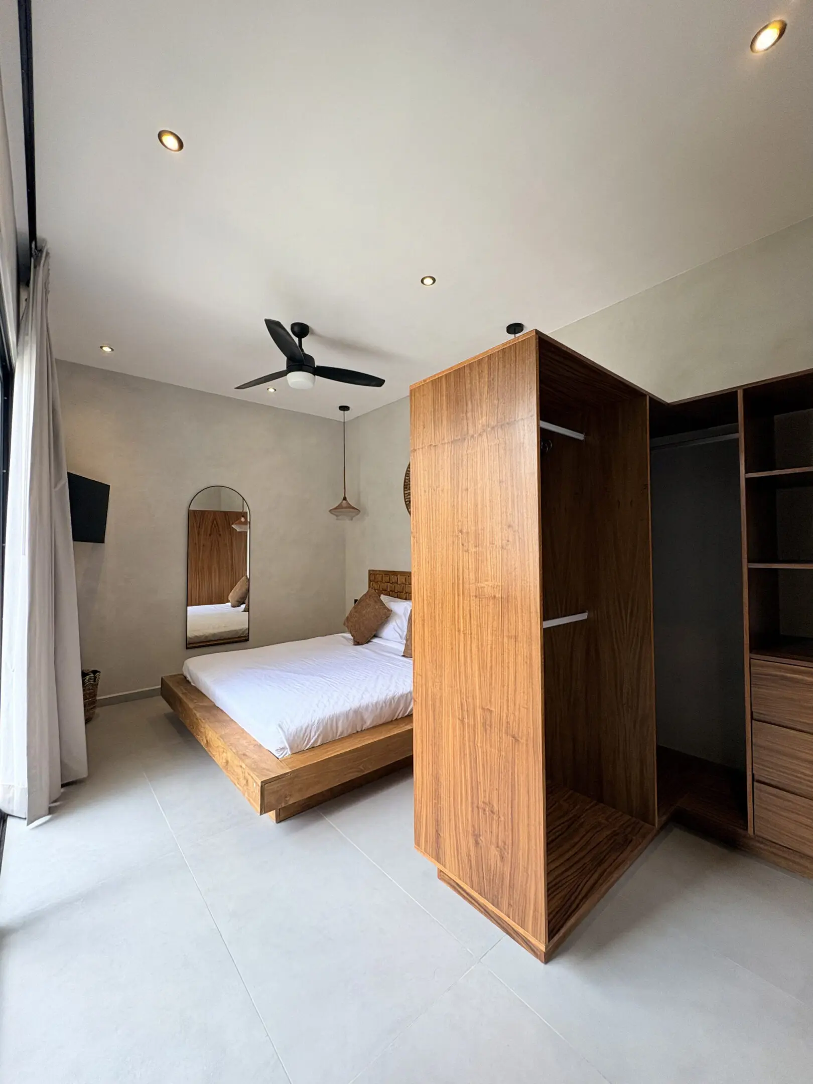 Minimalist bedroom with wooden bed and wardrobe