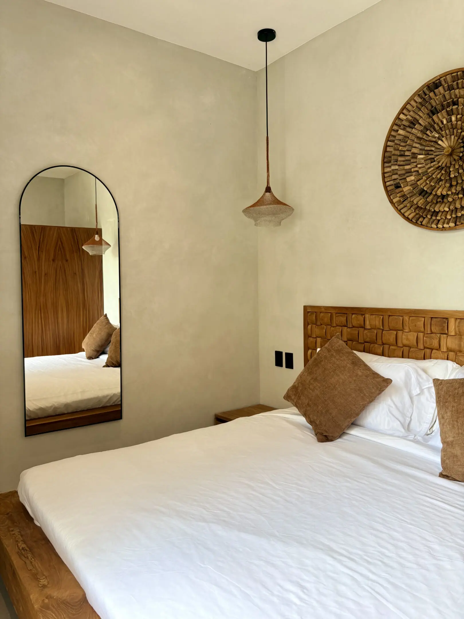 Minimal bedroom with white bedding and mirror