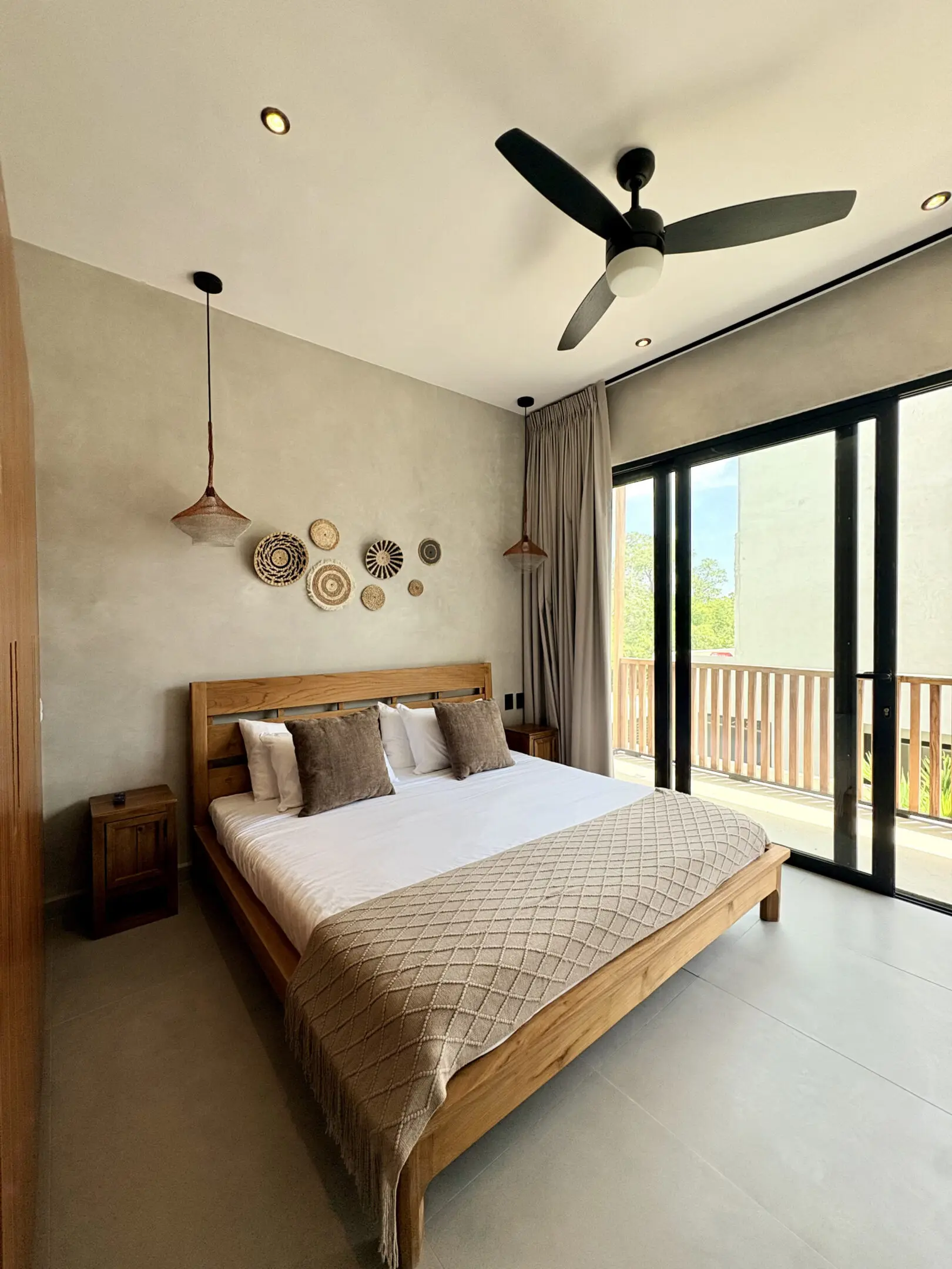 Modern bedroom with wooden bed and balcony