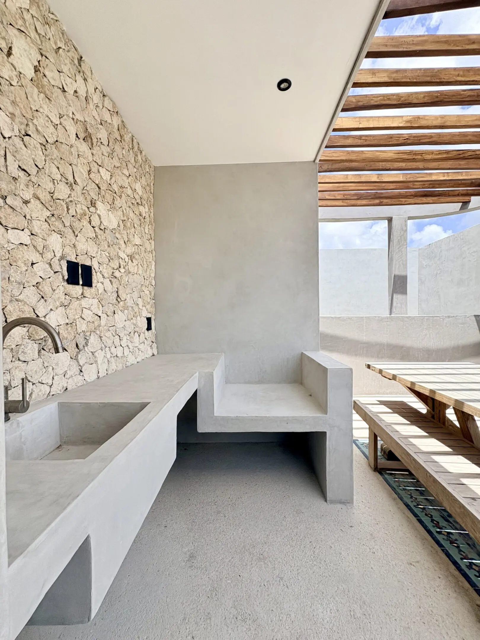 Minimalist outdoor concrete kitchen and seating