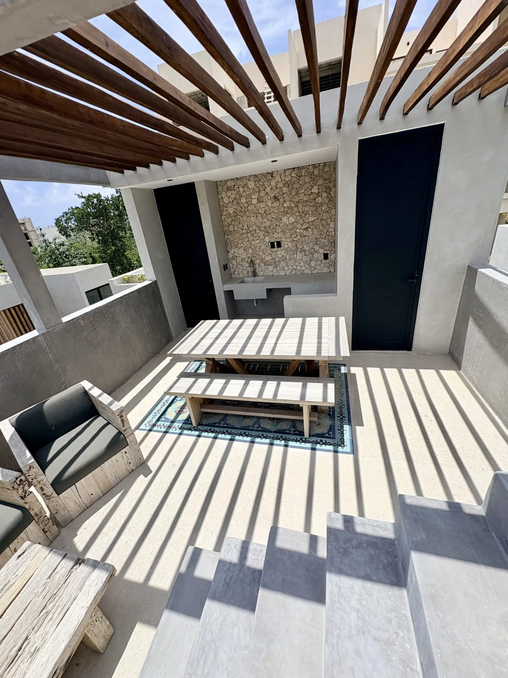 Rooftop pergola patio with bench and table