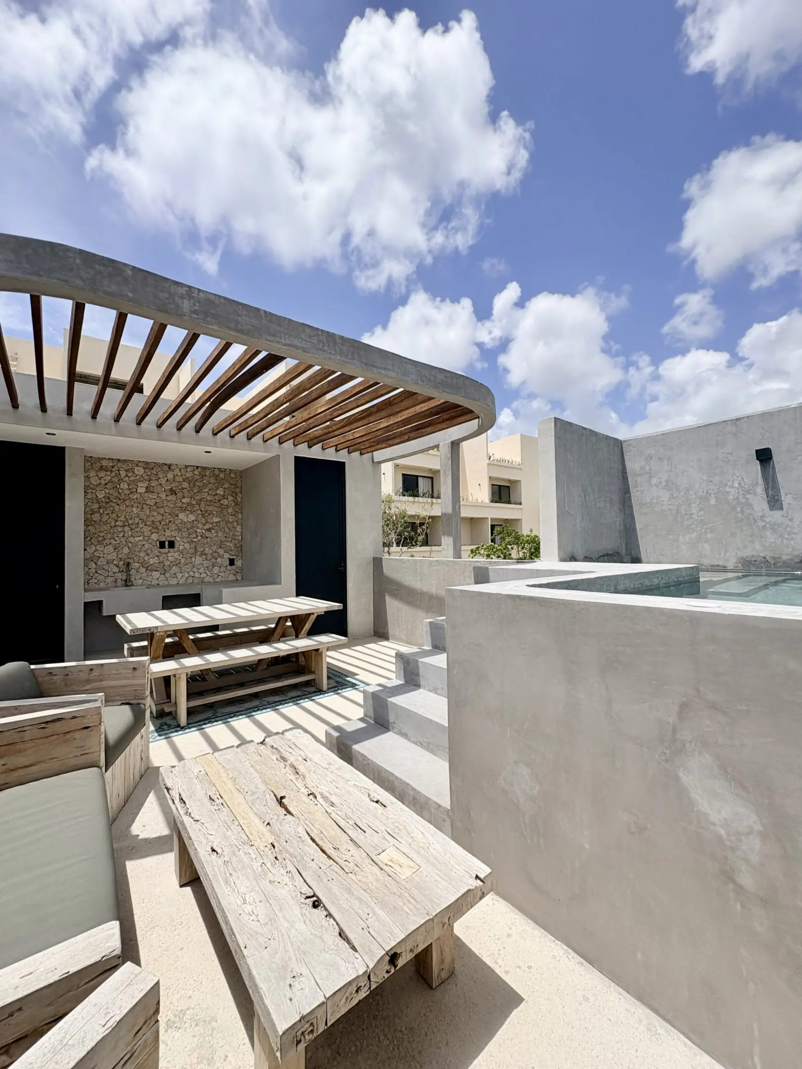 Modern rooftop patio with pergola and pool