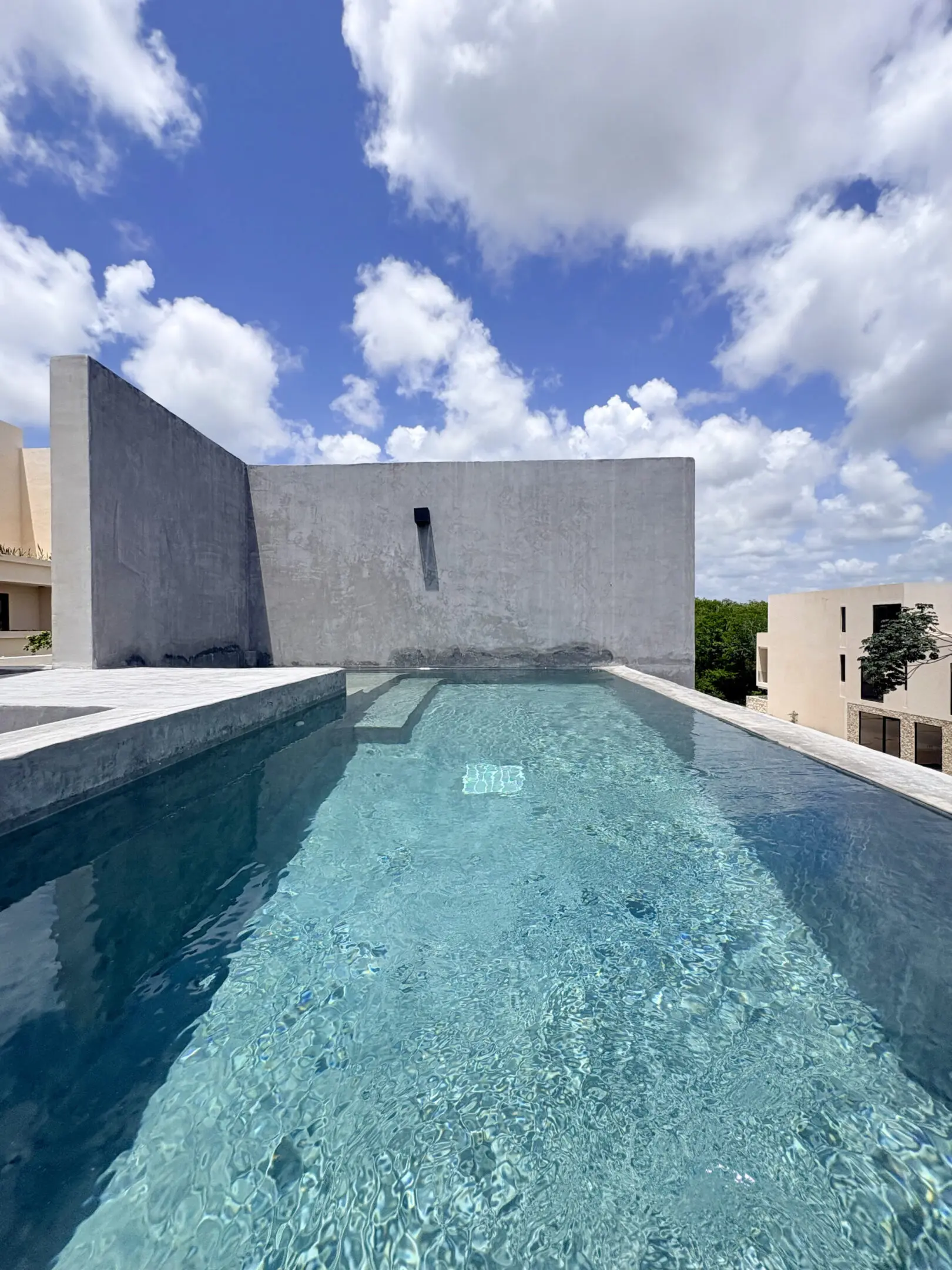 Rooftop infinity pool with blue sky