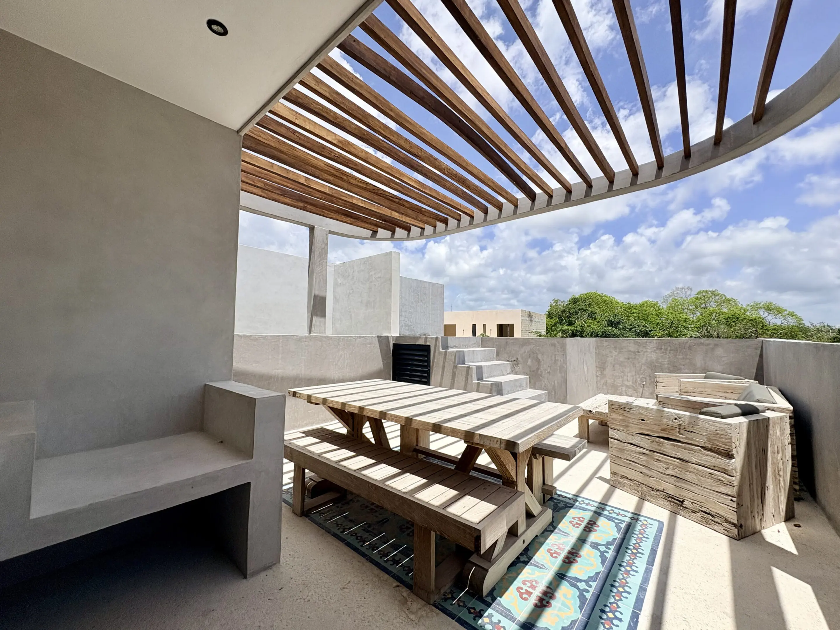 Rooftop patio with pergola and picnic table