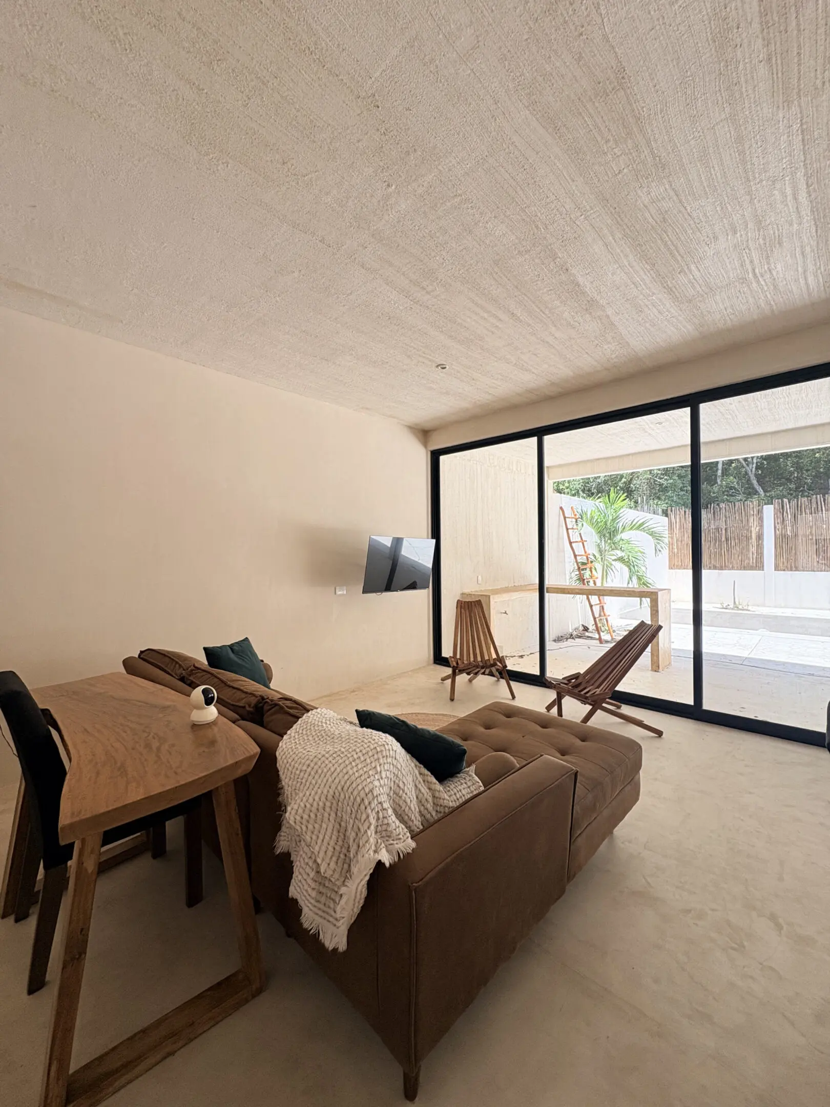 Minimalist living room with sofa and pool view