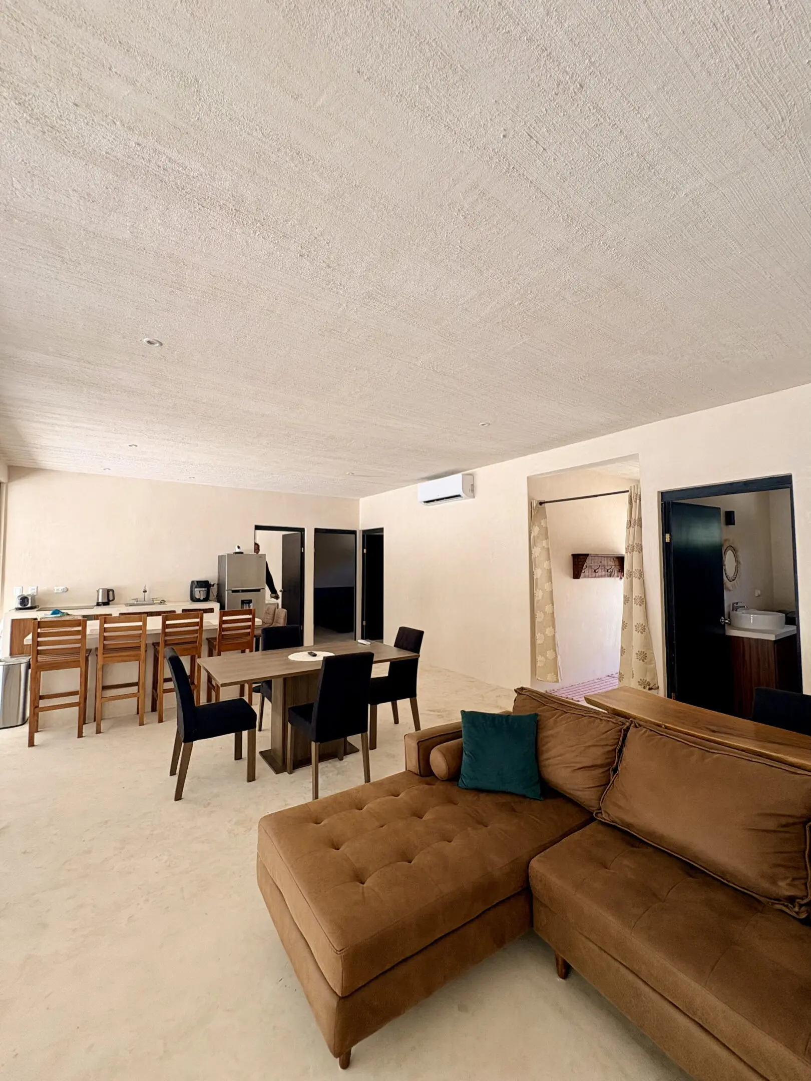 Modern open-plan living room with brown sofa