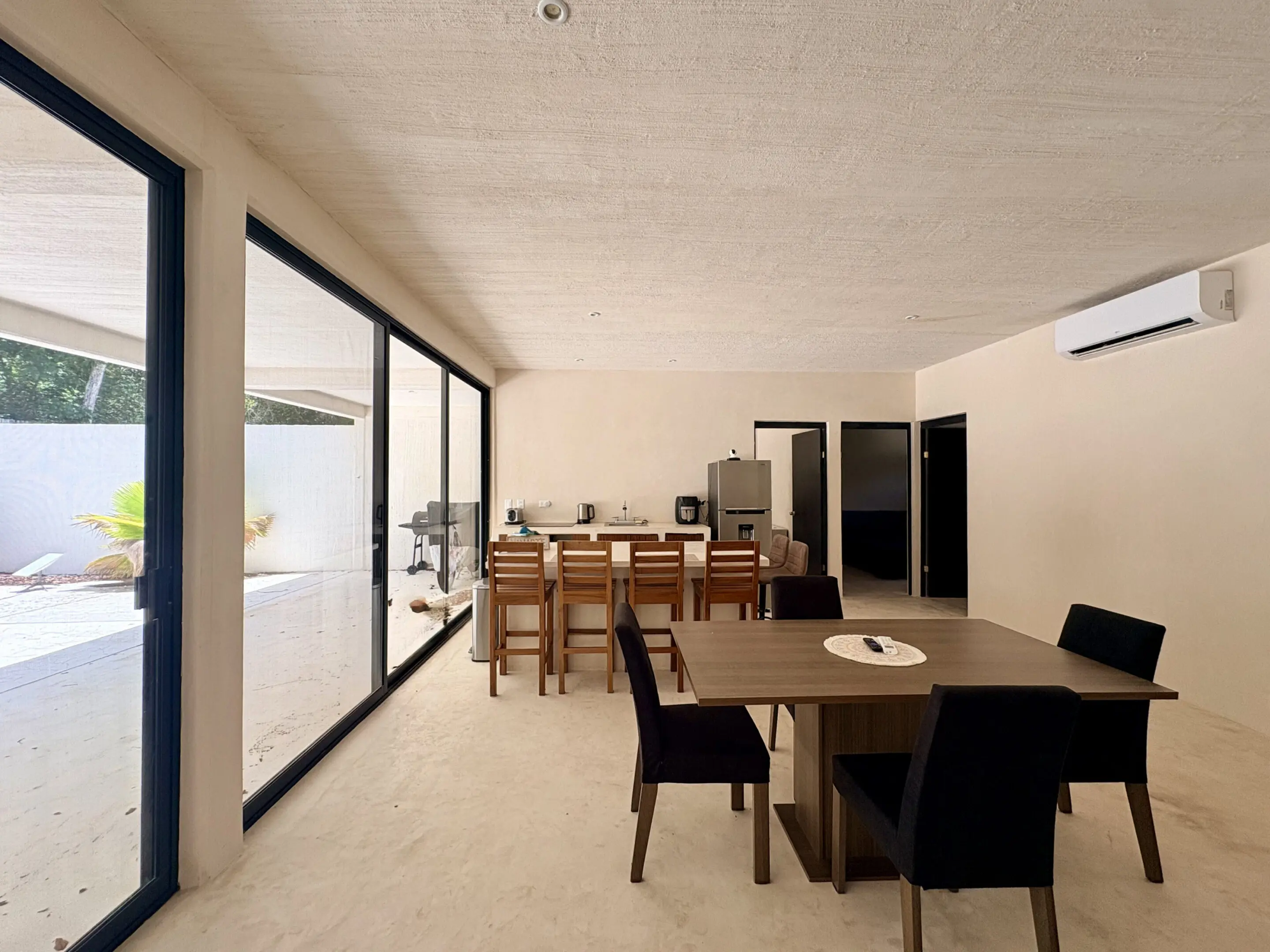 Open-plan dining and kitchen with glass doors
