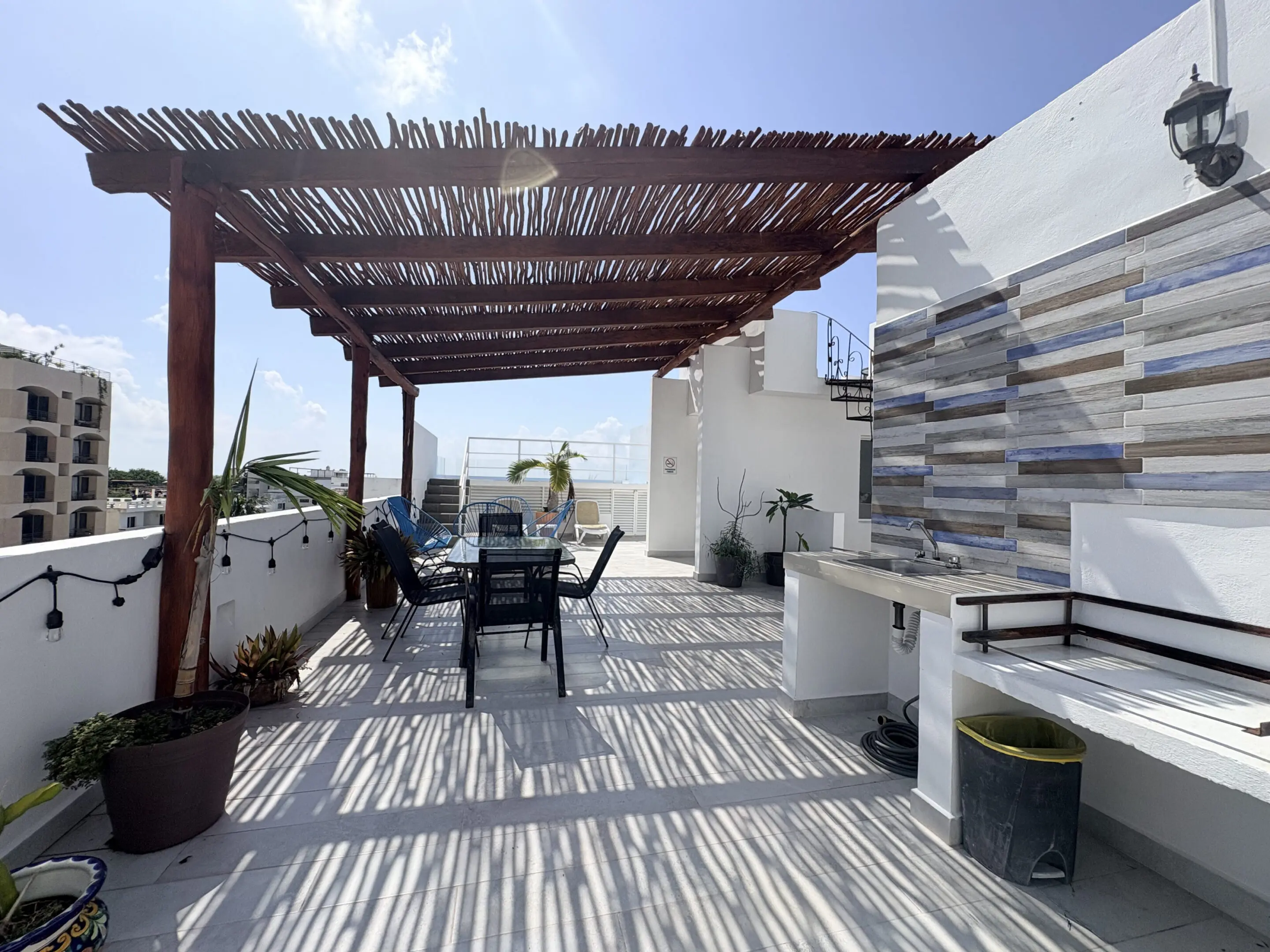 Rooftop terrace with wooden pergola and seating