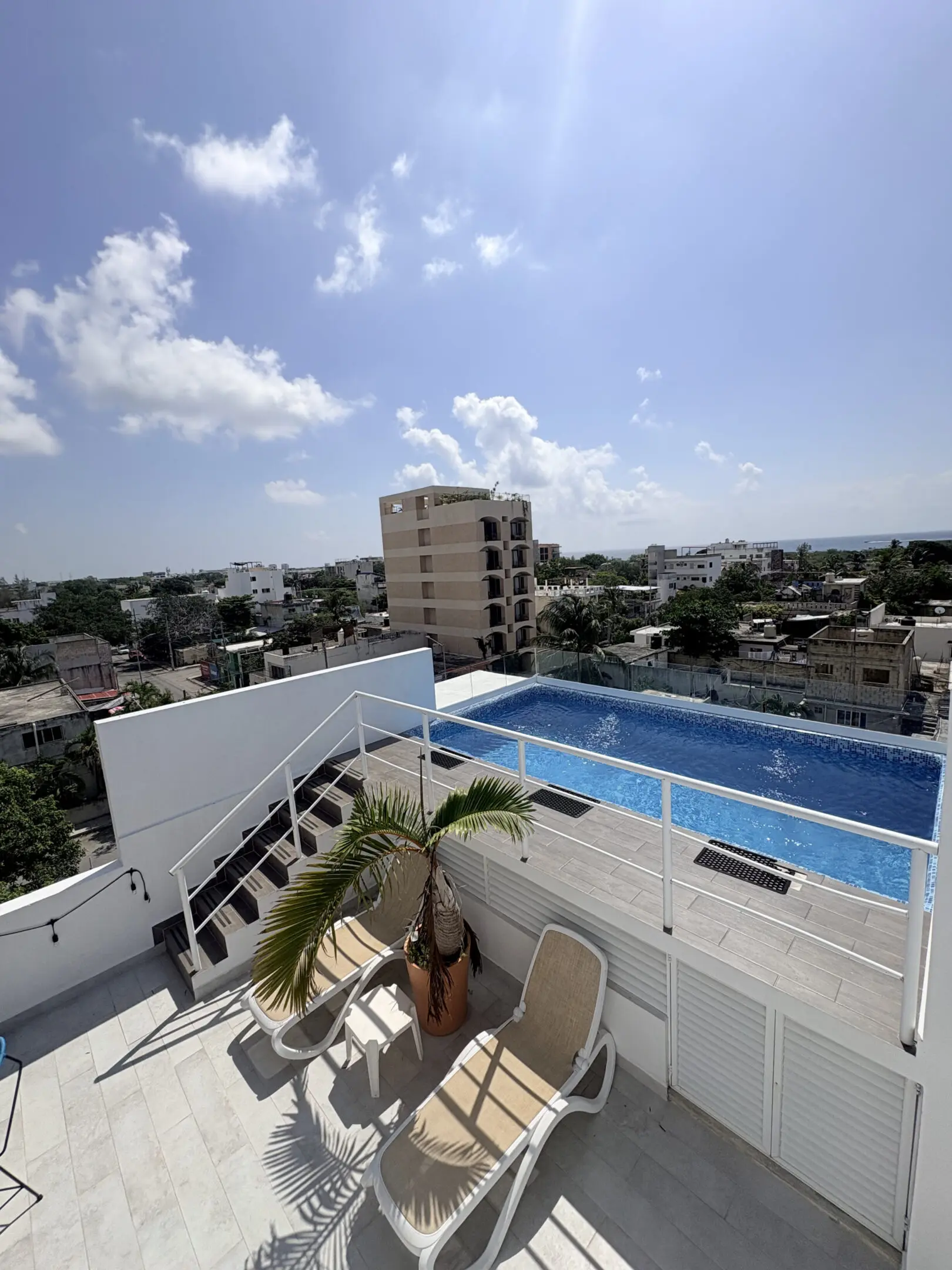 Rooftop pool with lounge chairs and cityscape