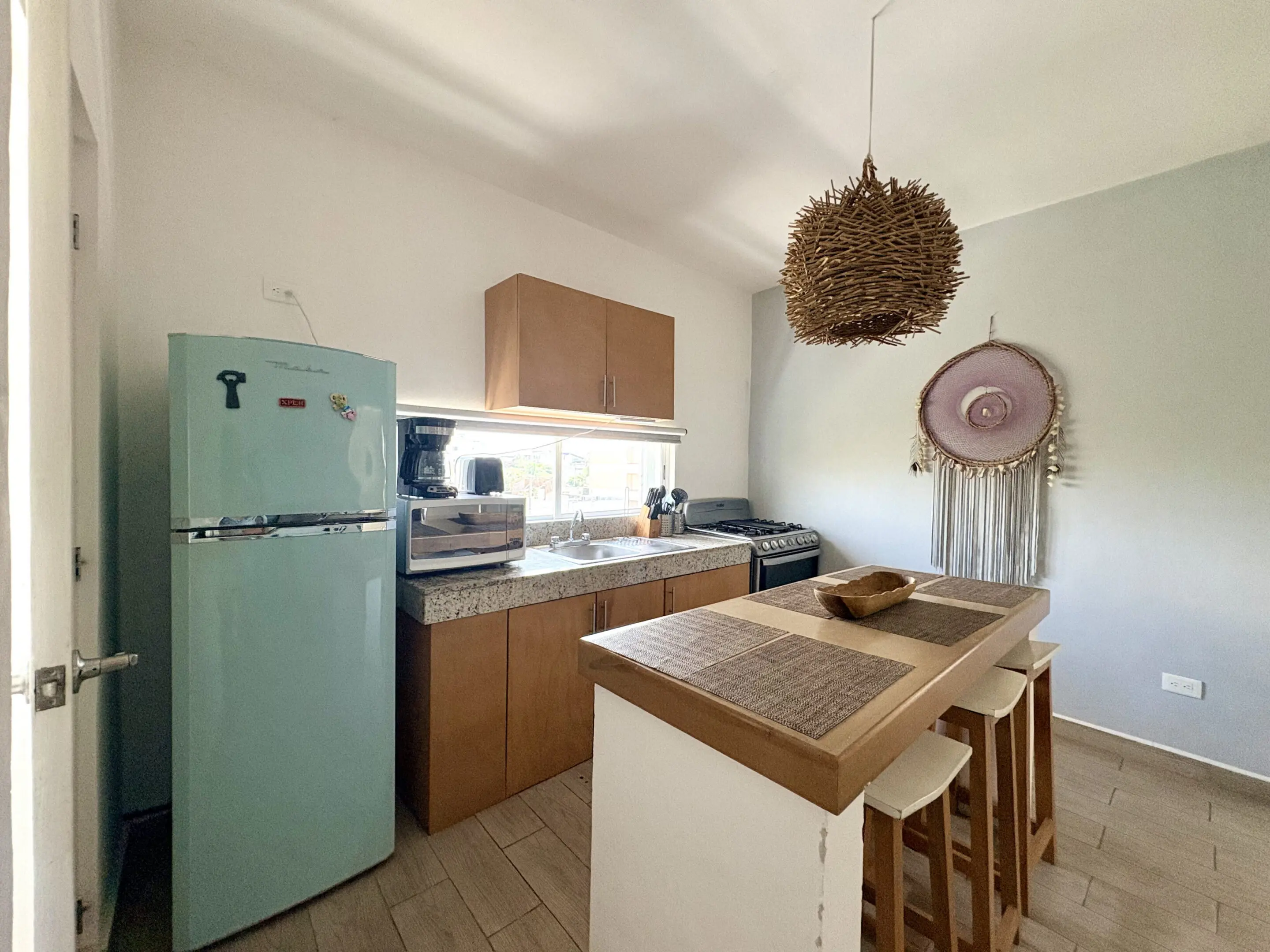 Cozy modern kitchen with island and mint fridge