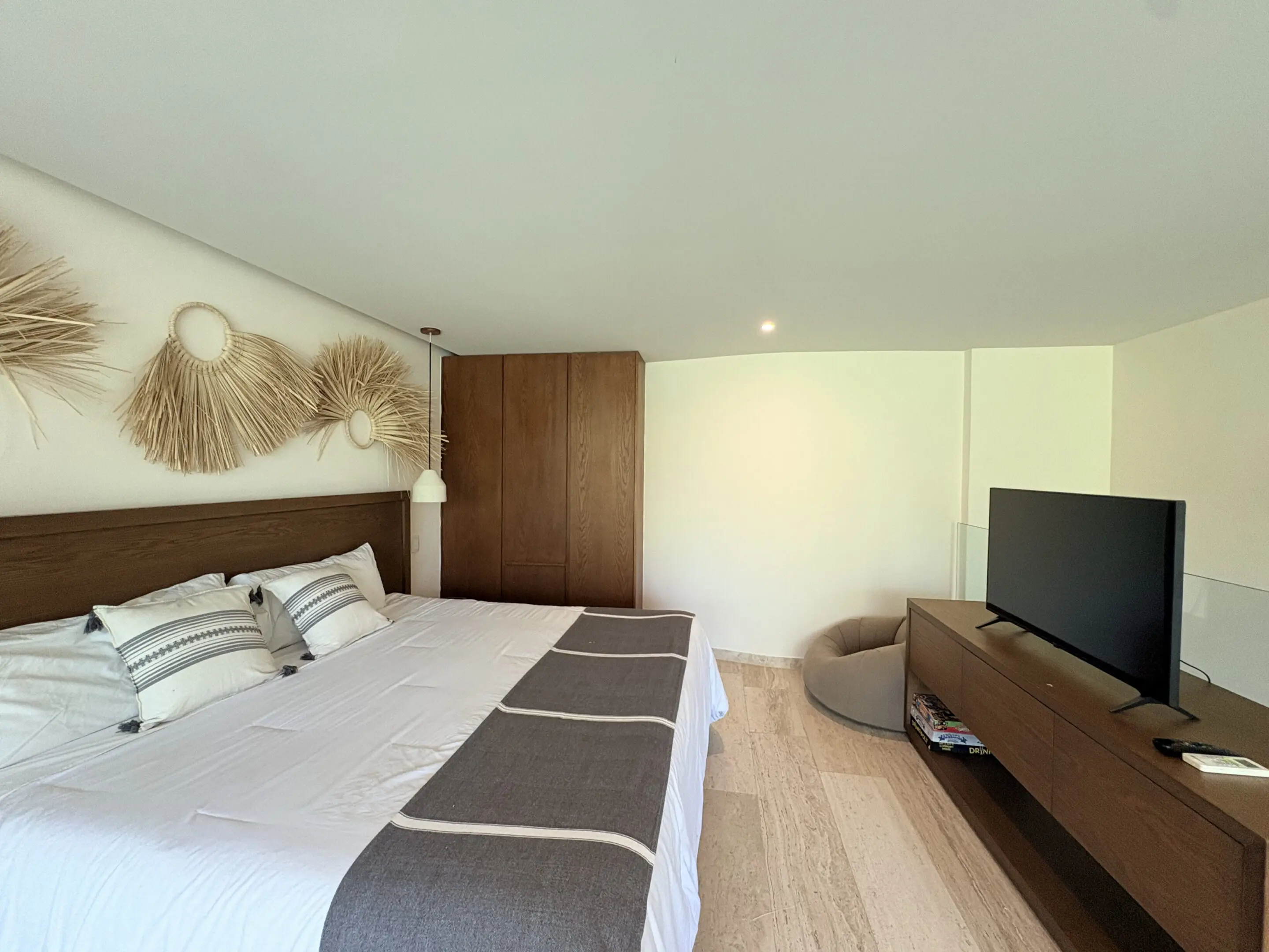 Modern bedroom with king bed and TV