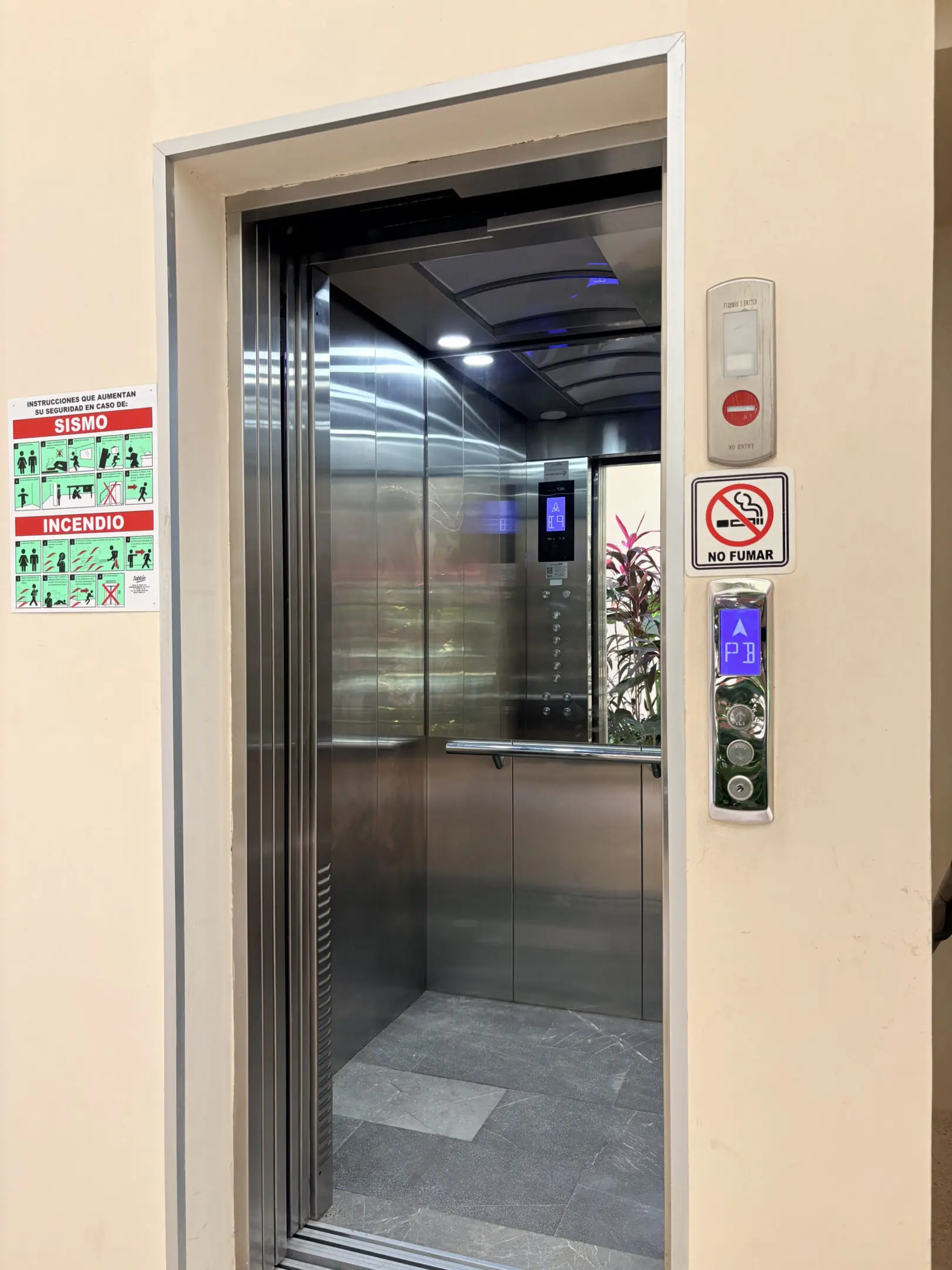 Open stainless steel elevator with control panel