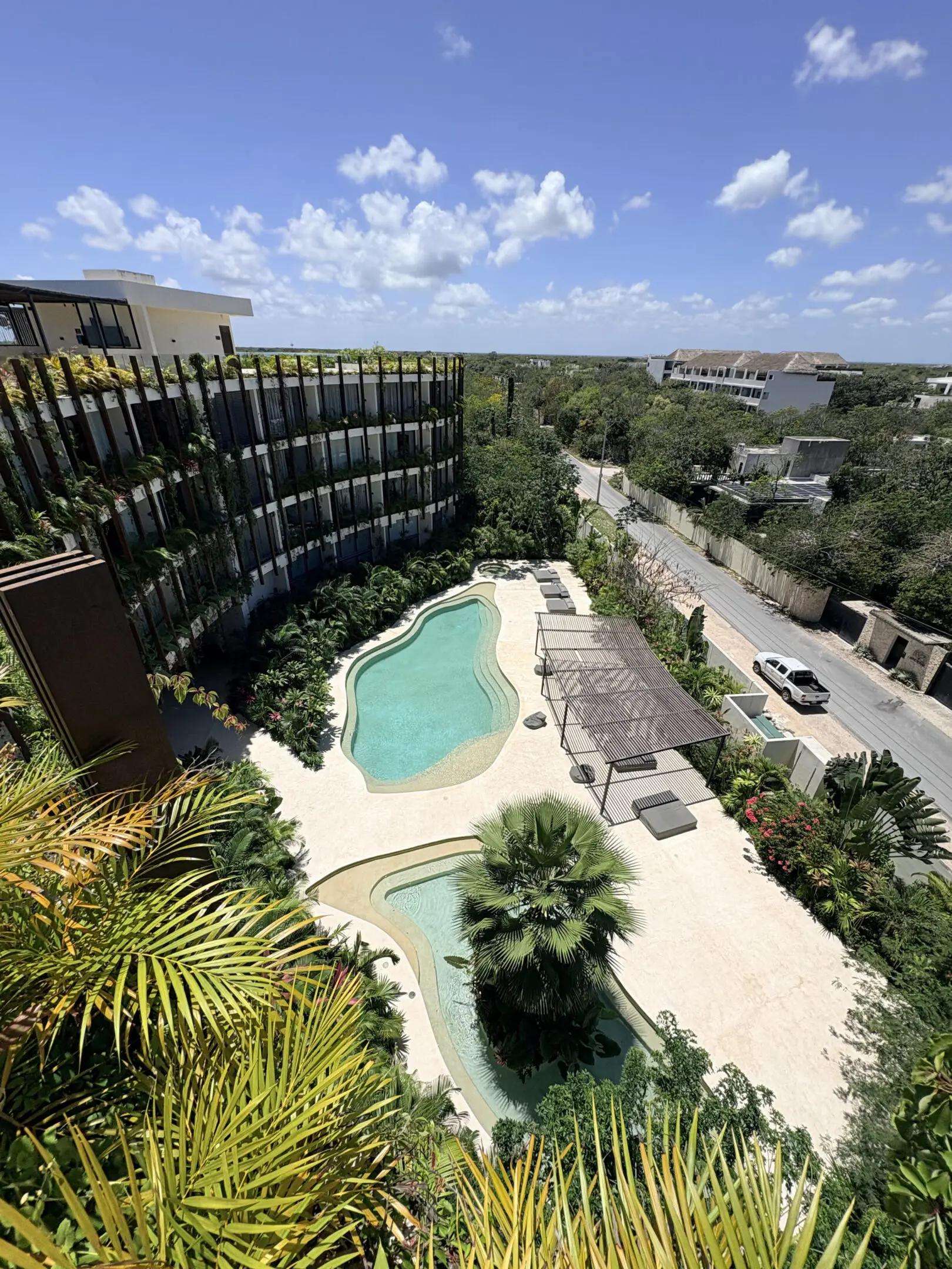 Modern resort courtyard with curved swimming pools