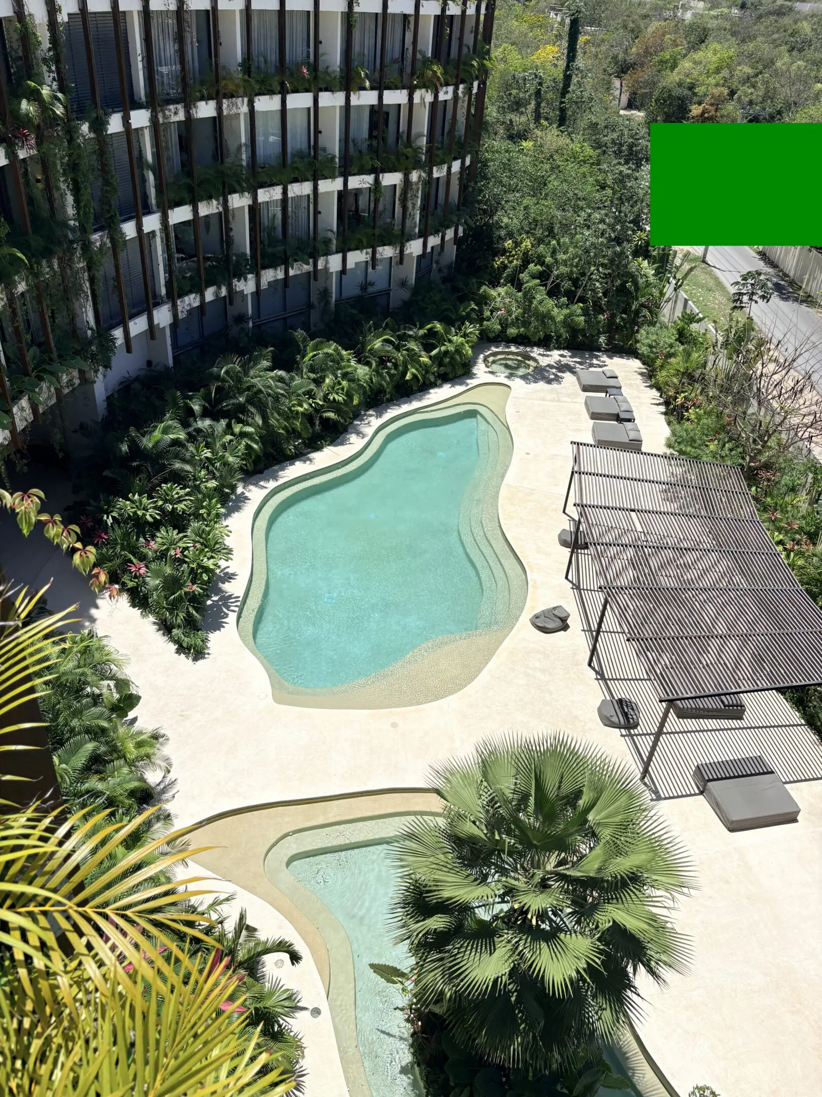Hotel courtyard with two freeform swimming pools
