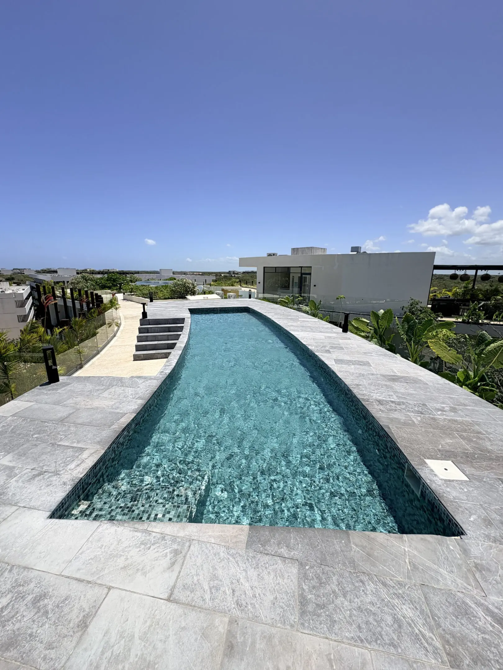 Rooftop infinity pool with modern white villa