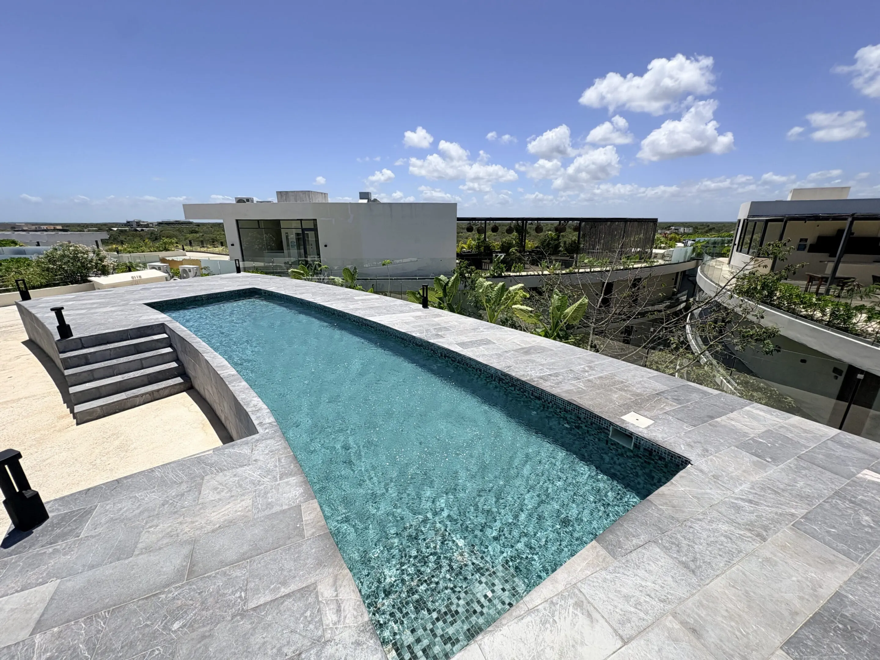 Rooftop infinity pool overlooking modern residences