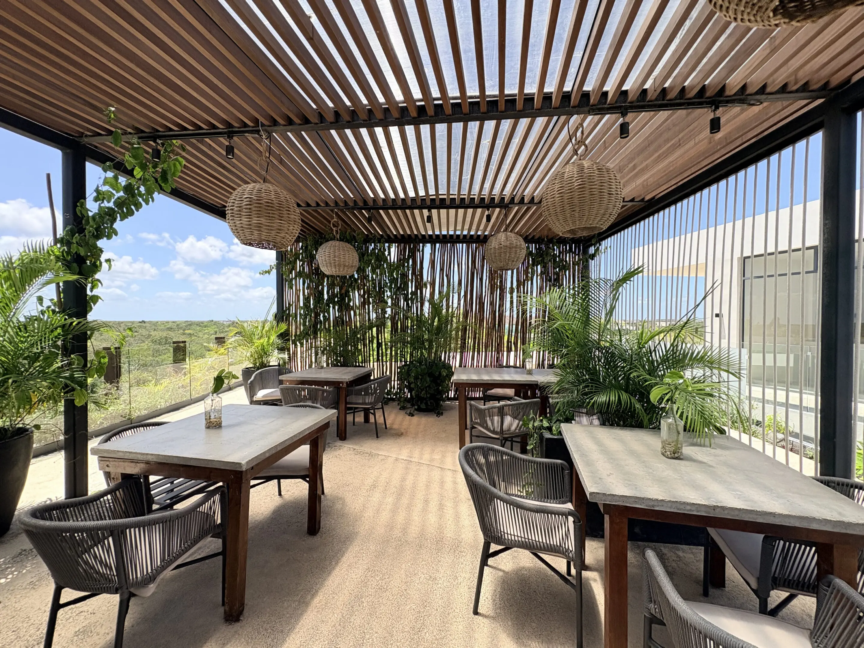 Outdoor pergola cafe with rattan chairs