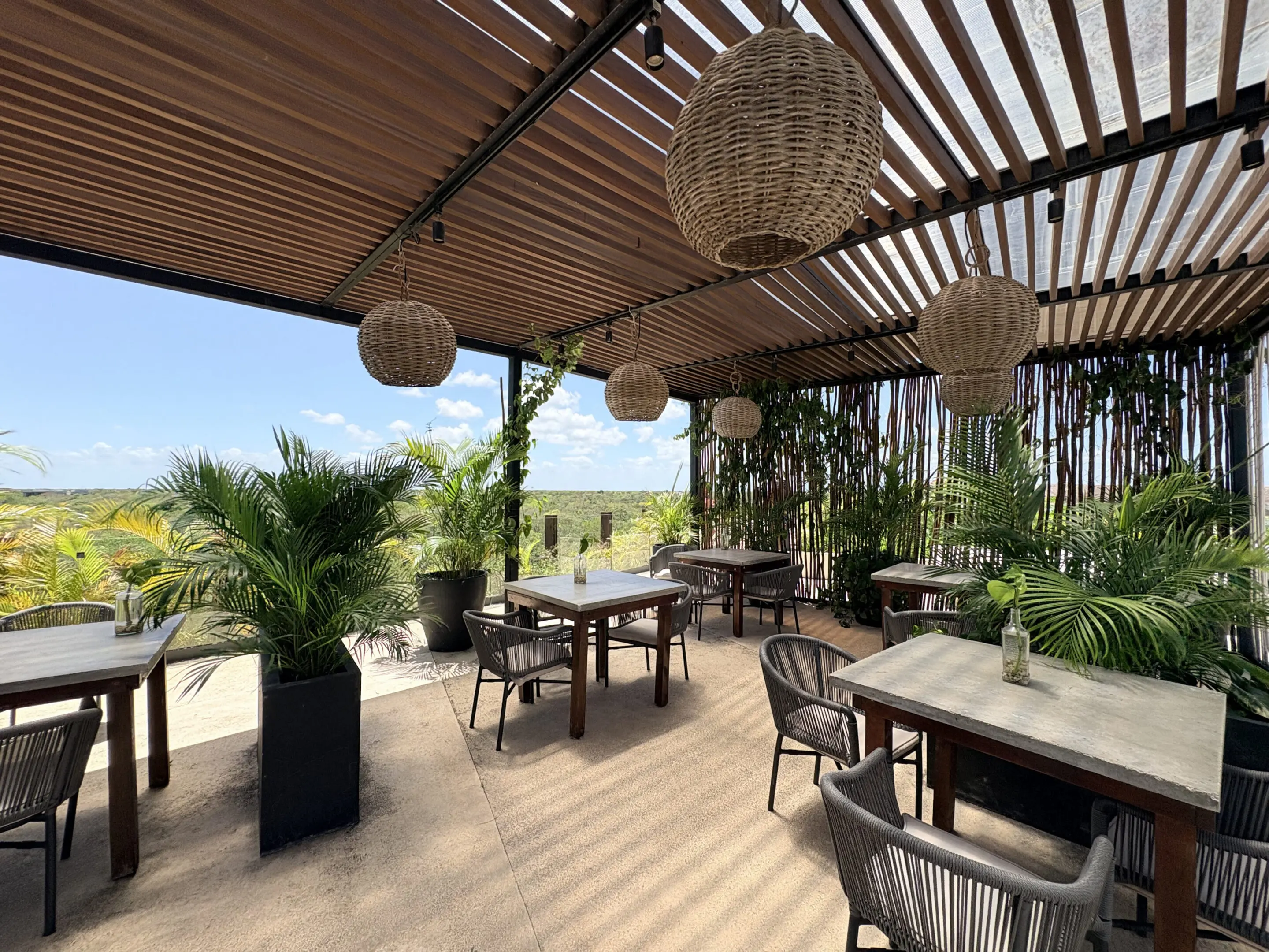 Tropical outdoor restaurant patio with wicker lanterns