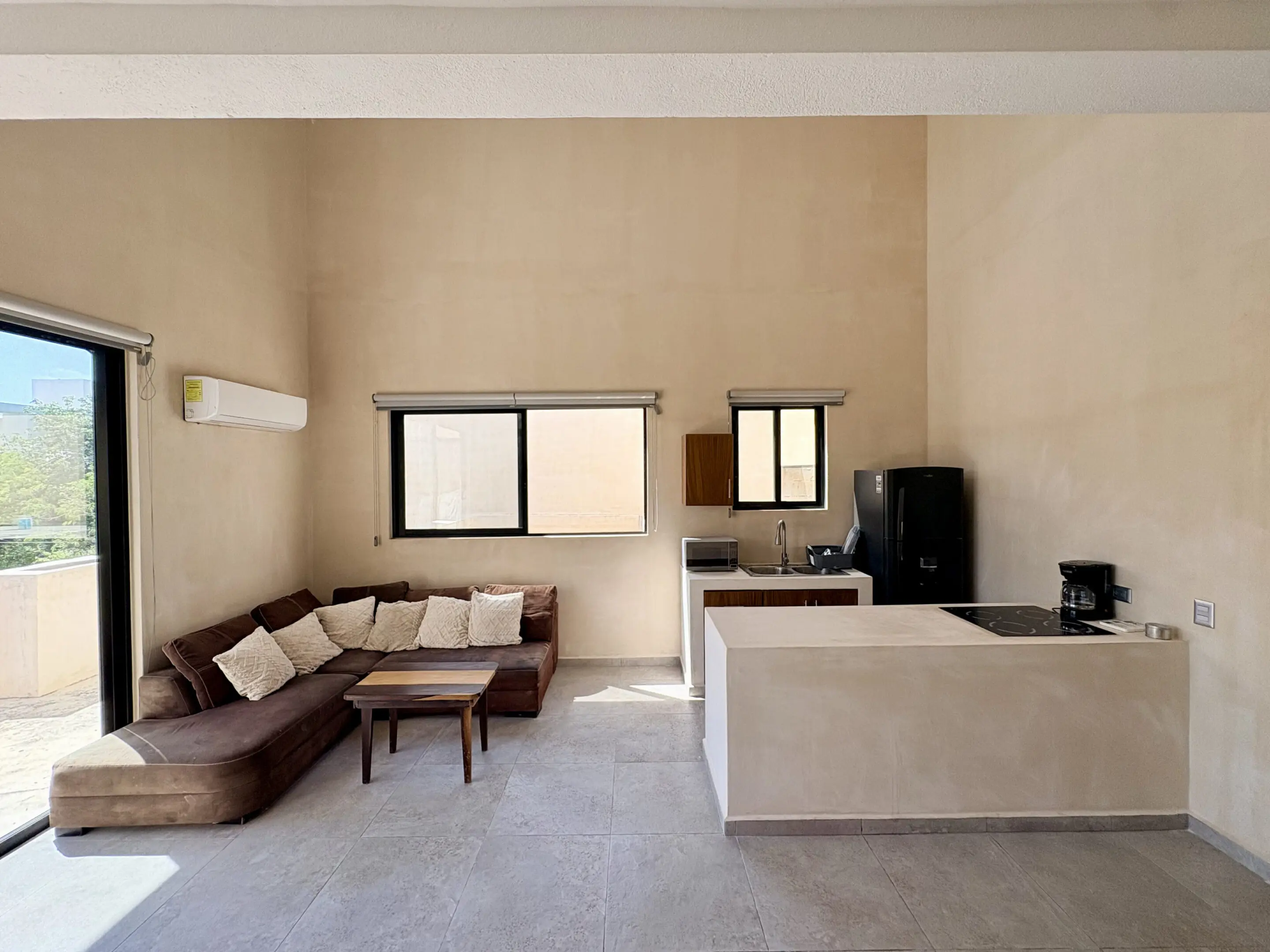 Open-plan living area with sectional sofa, kitchen island