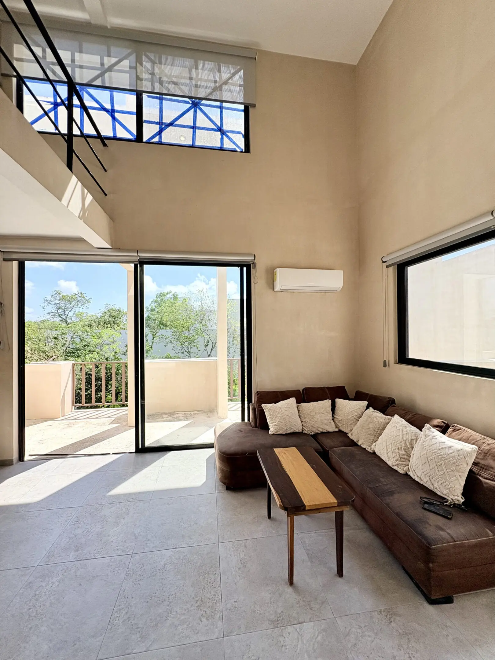 Sunlit modern living room with sectional sofa
