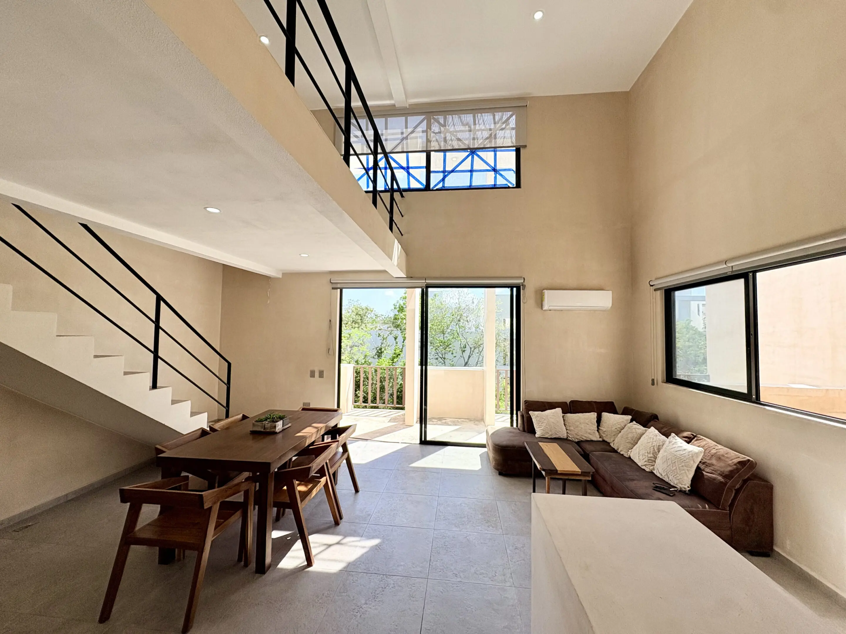 Modern open-plan living room with loft staircase