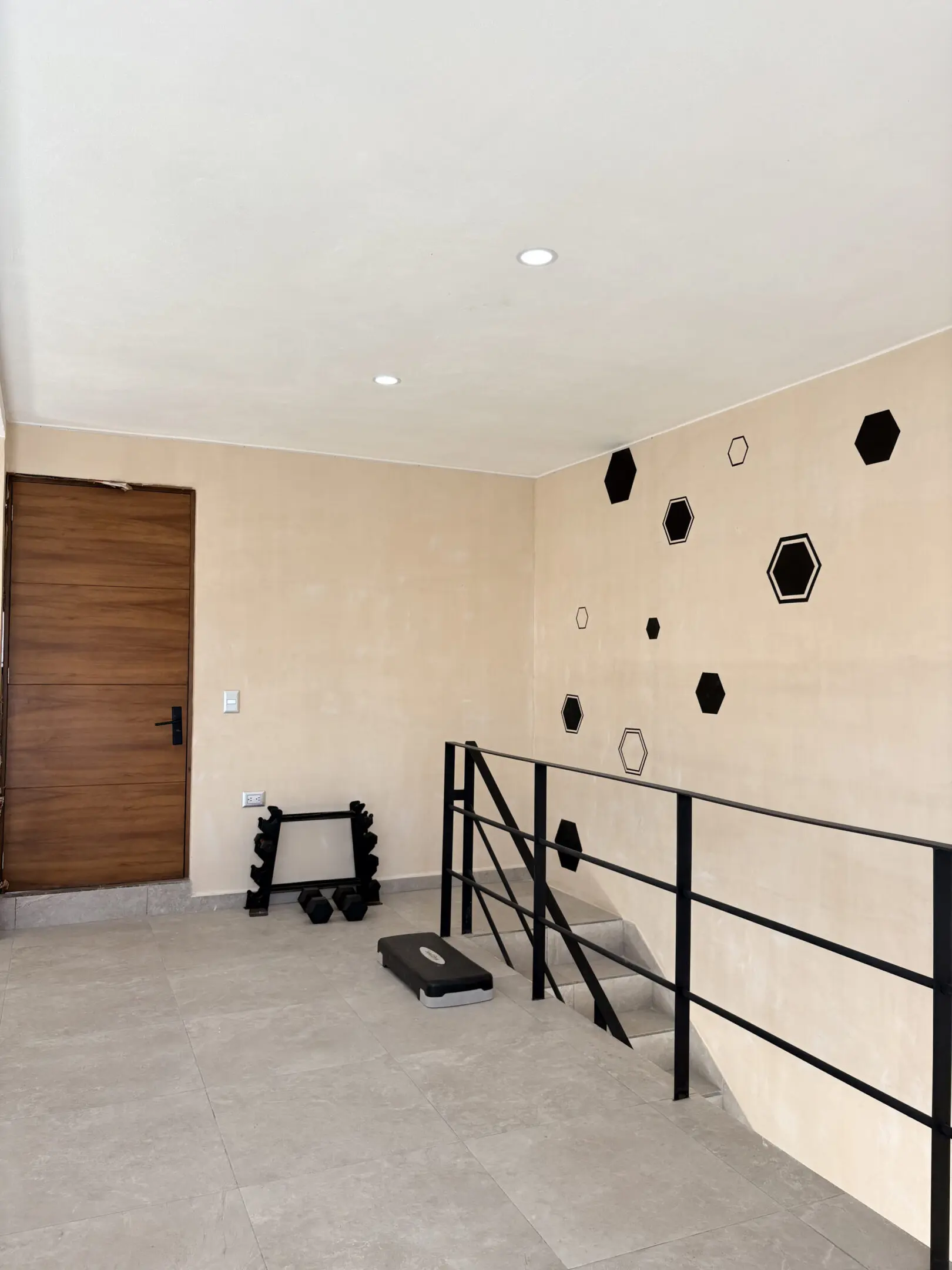 Minimal home gym landing with hexagon wall decor