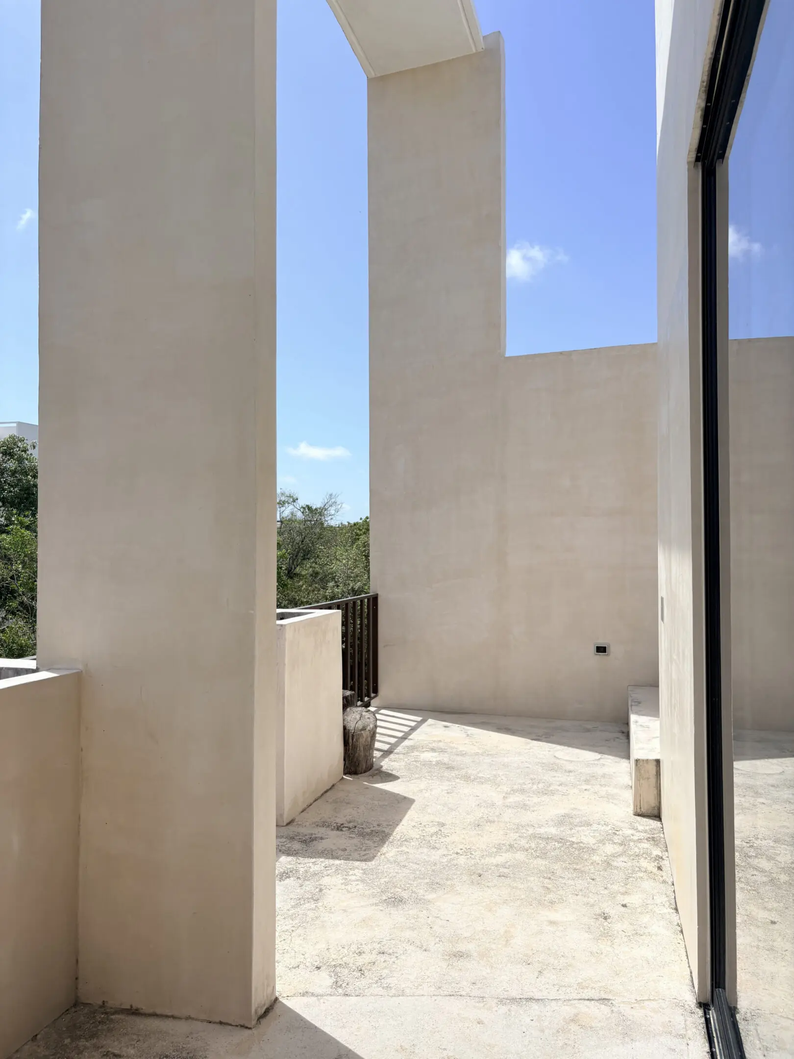 Minimalist beige courtyard with tall pillars