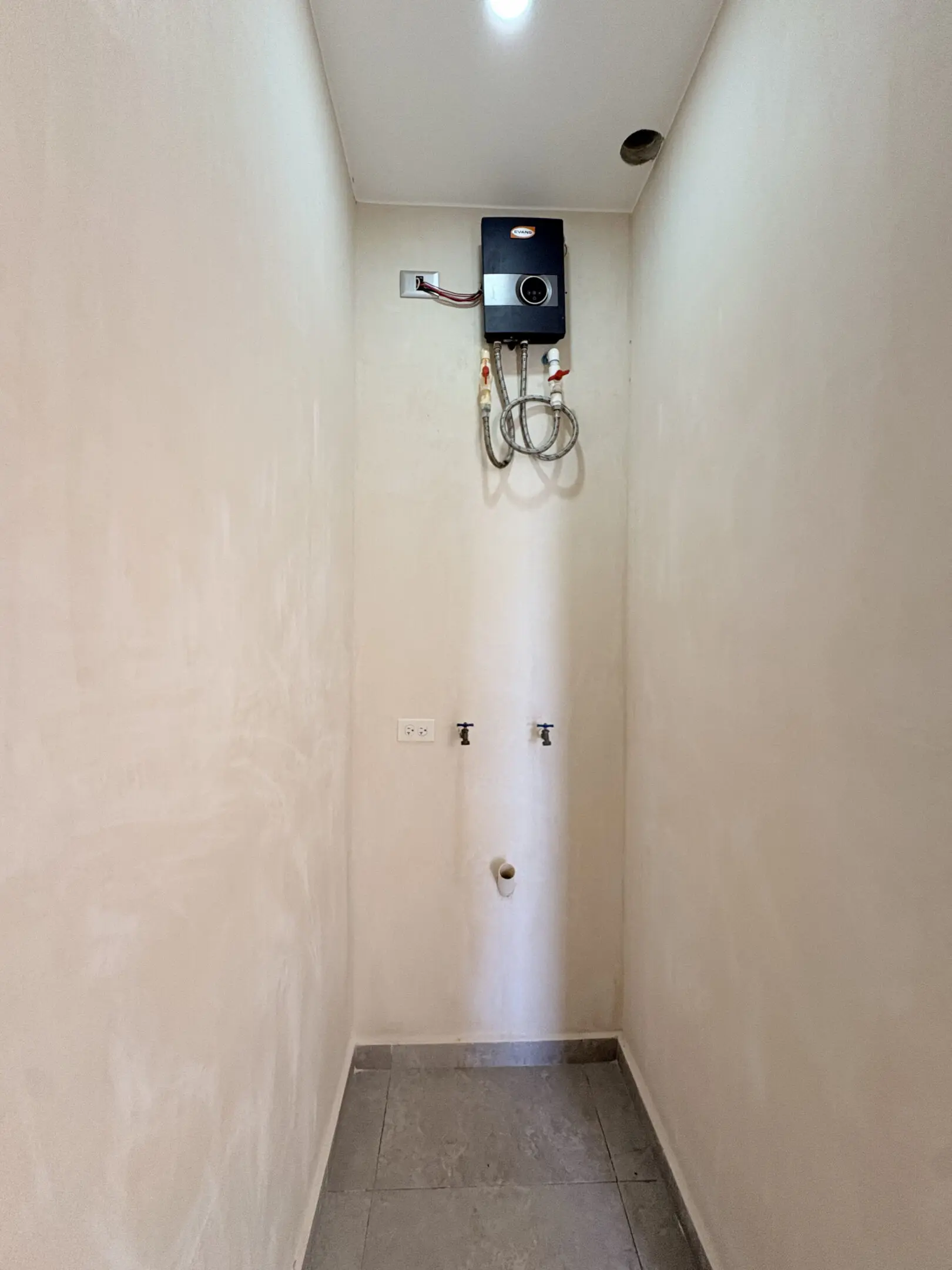 Narrow utility closet with mounted water heater