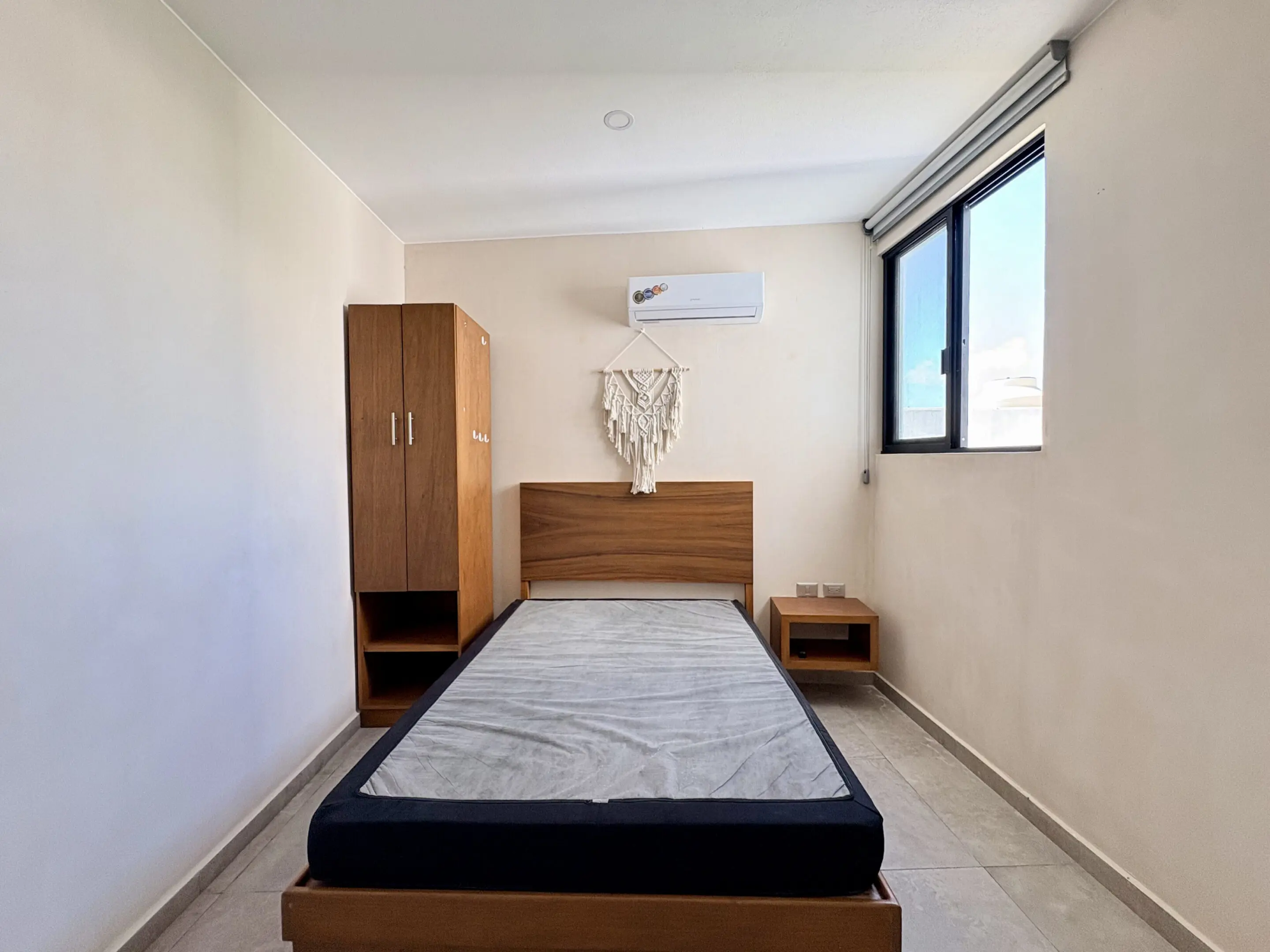 Minimalist single bedroom with bed and wardrobe