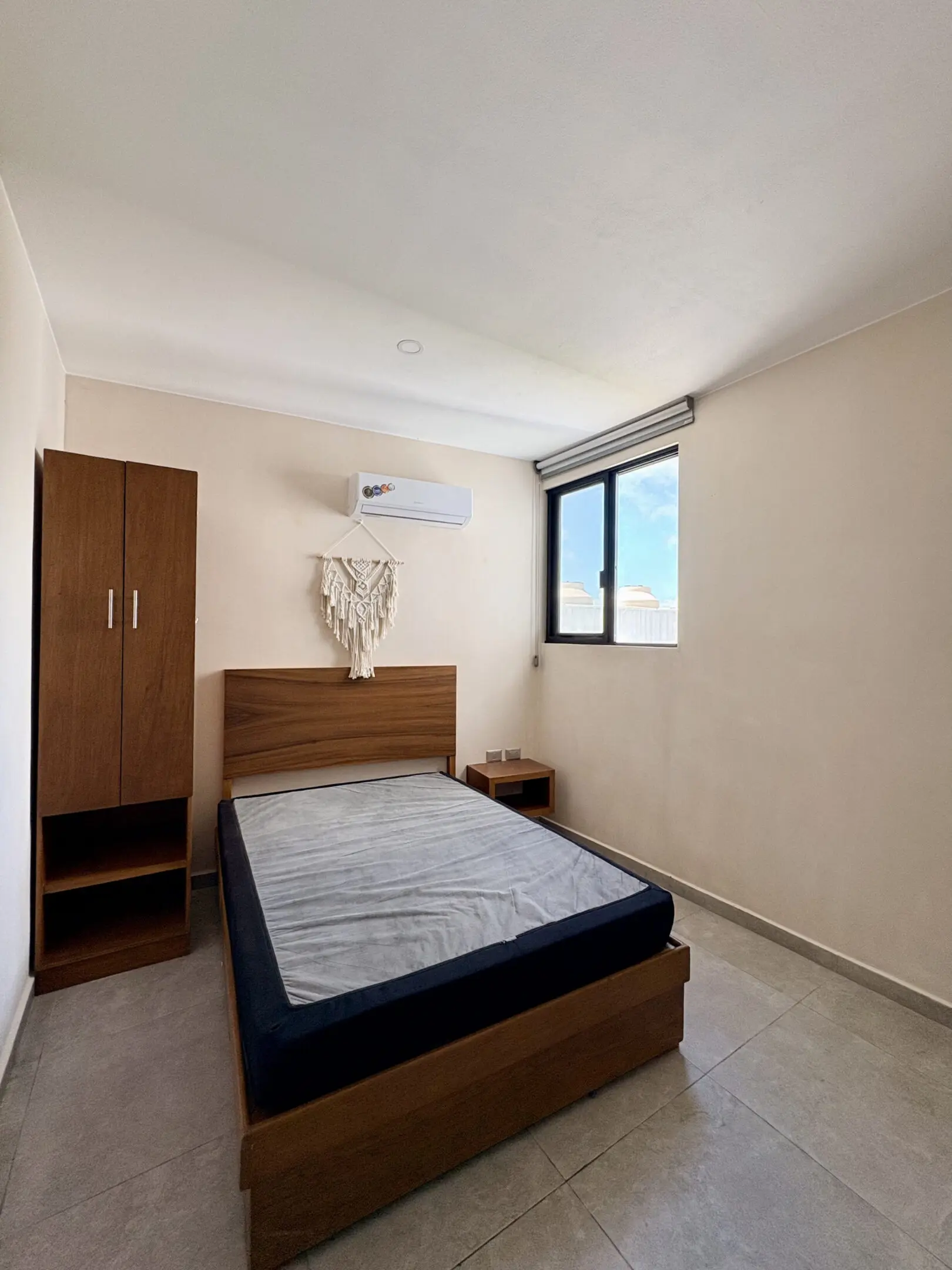 Minimal single bedroom with bed and wardrobe