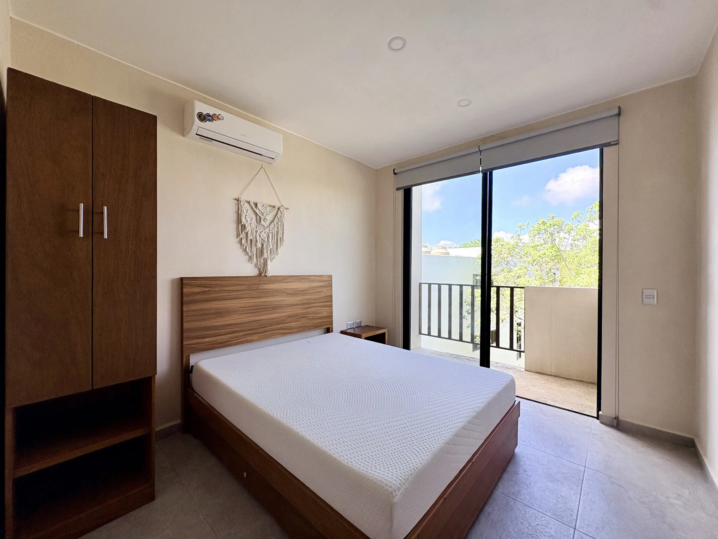 Bright modern bedroom with bed and balcony