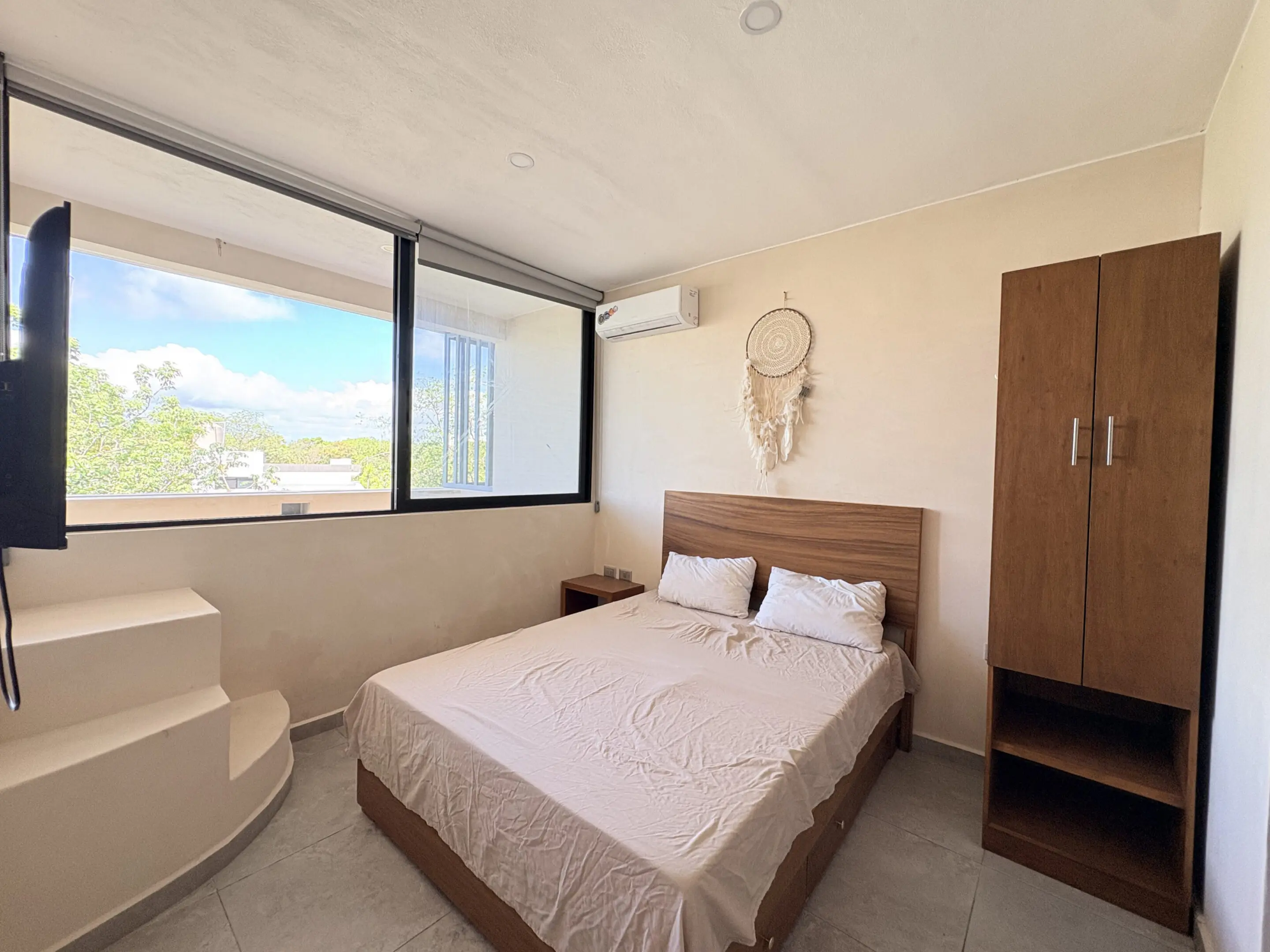 Bright bedroom with double bed and wardrobe