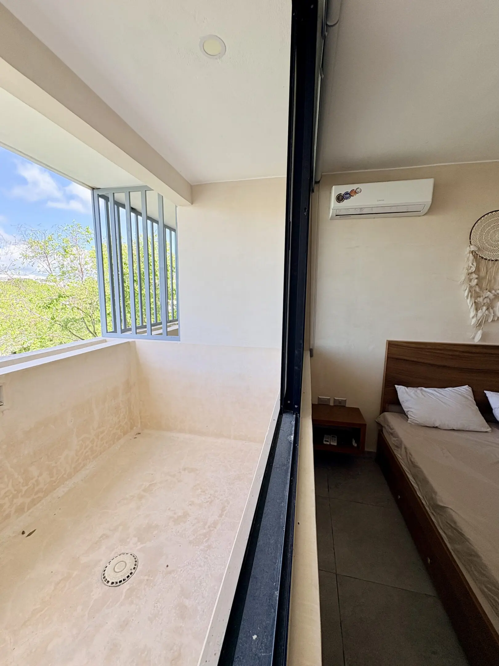 Air-conditioned bedroom with adjacent tiled balcony