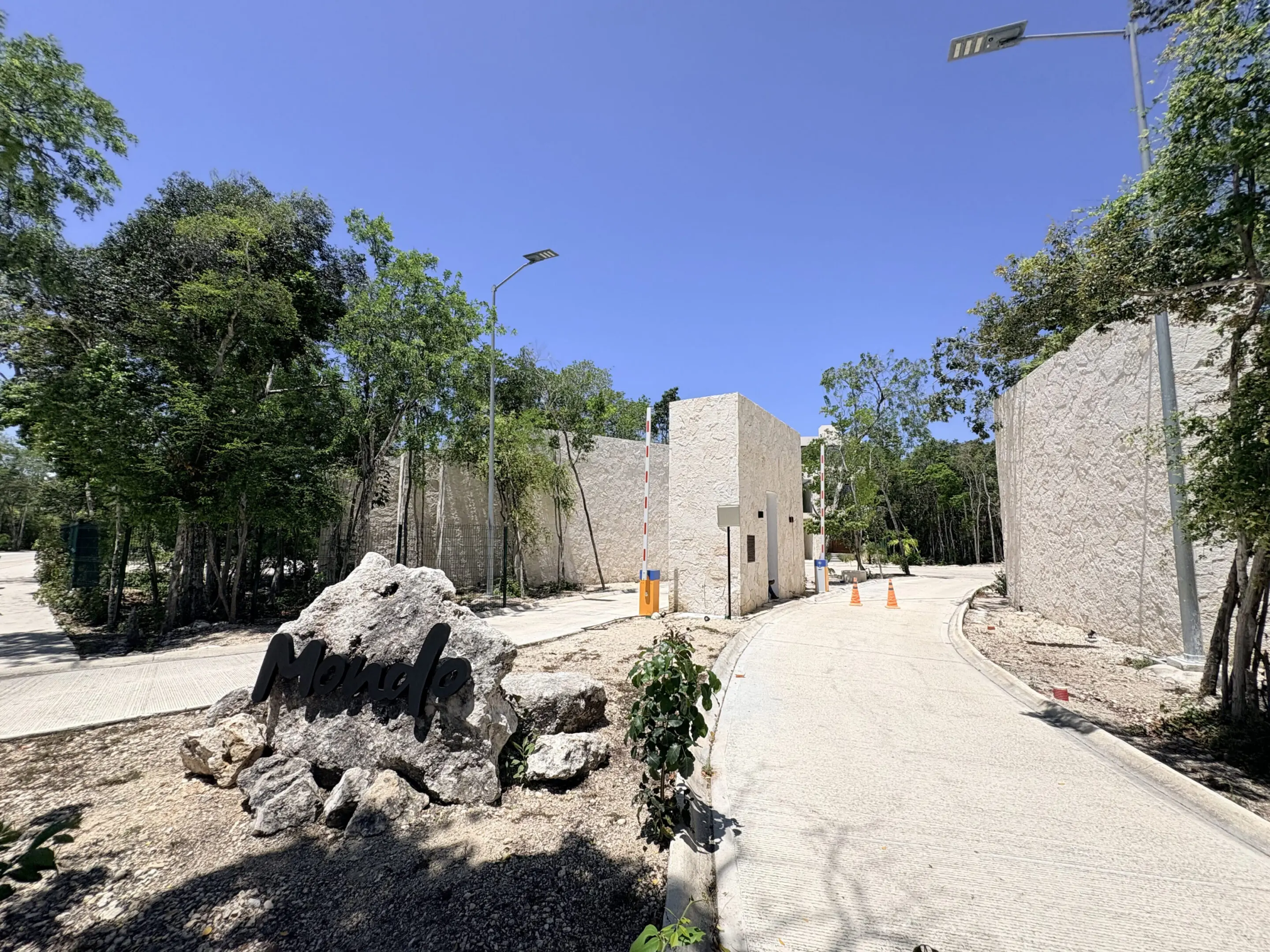 Stone-walled resort entrance with curved driveway