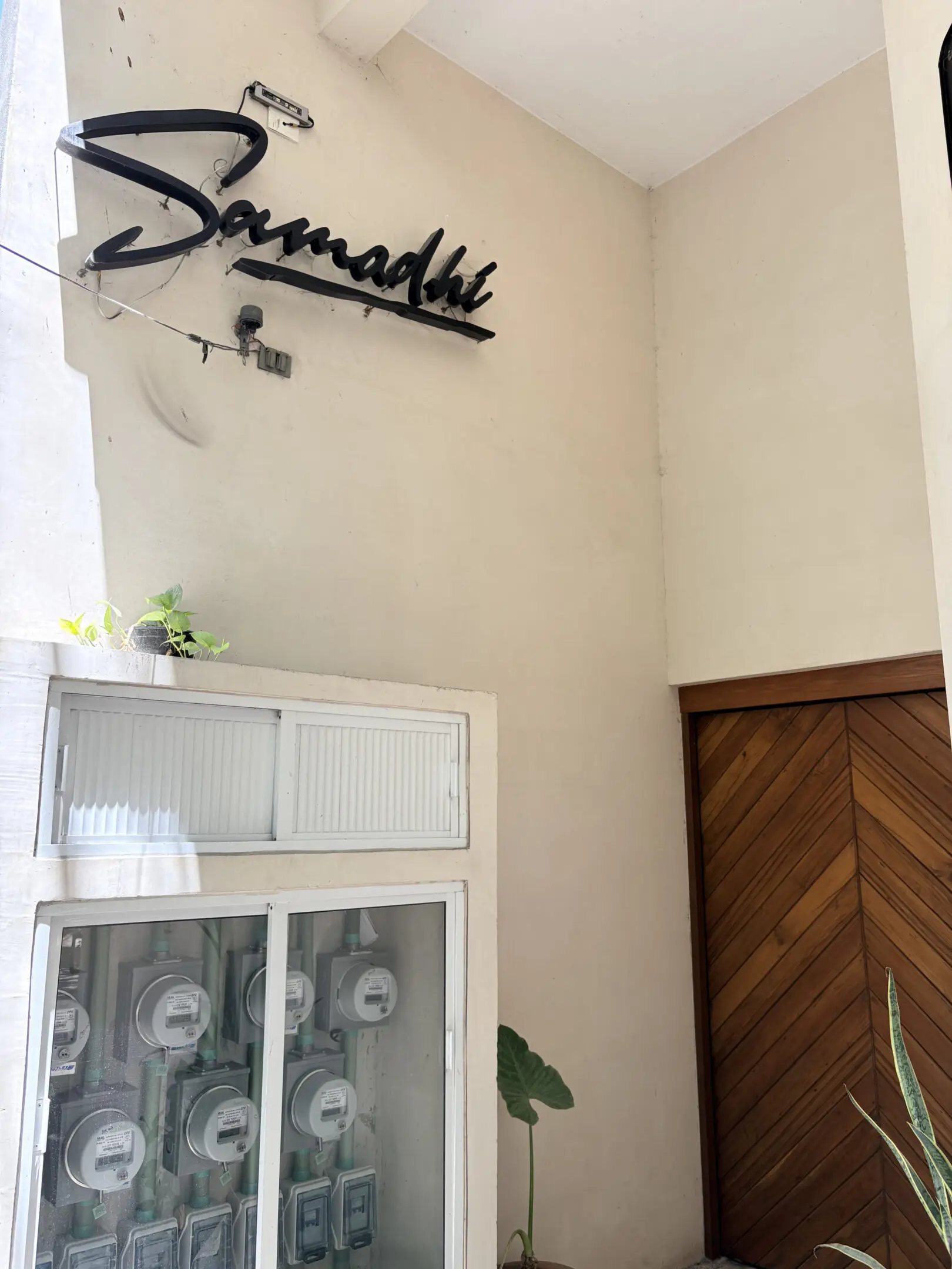 Building entrance with "Samadhi" sign and meters