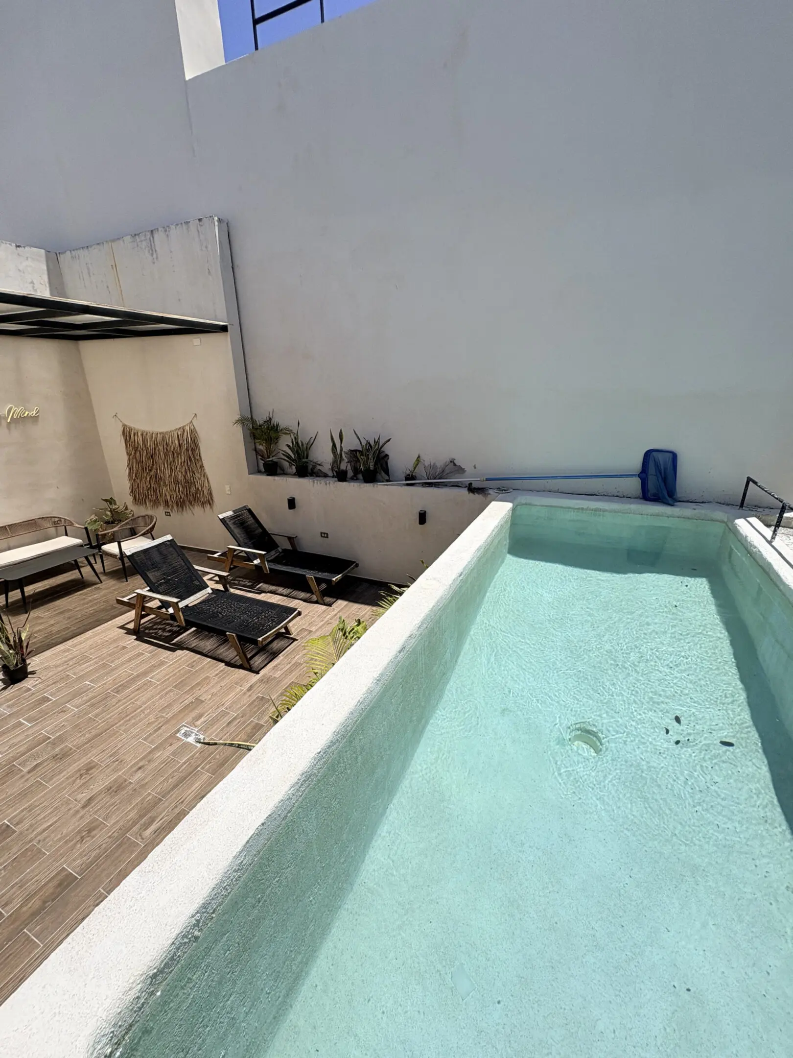 Rooftop pool with lounge chairs and patio