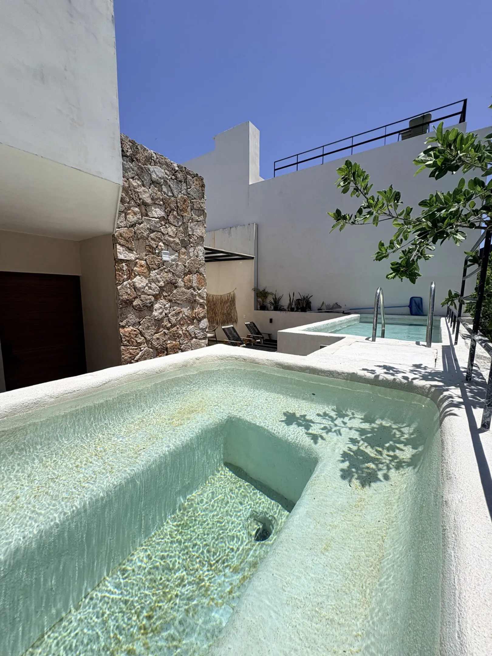 Sunlit courtyard with cascading plunge pools