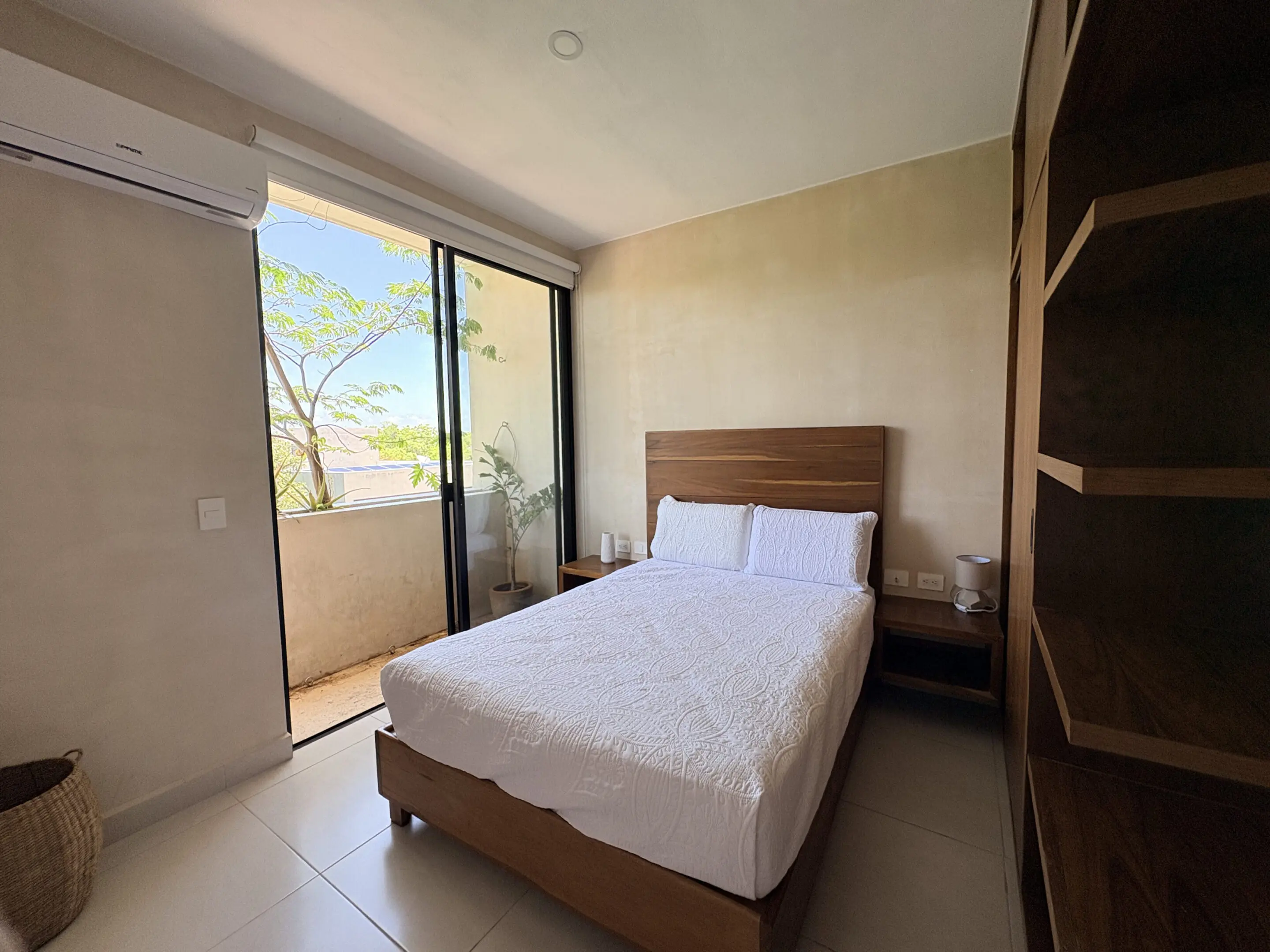 Minimalist bedroom with balcony and wooden bed