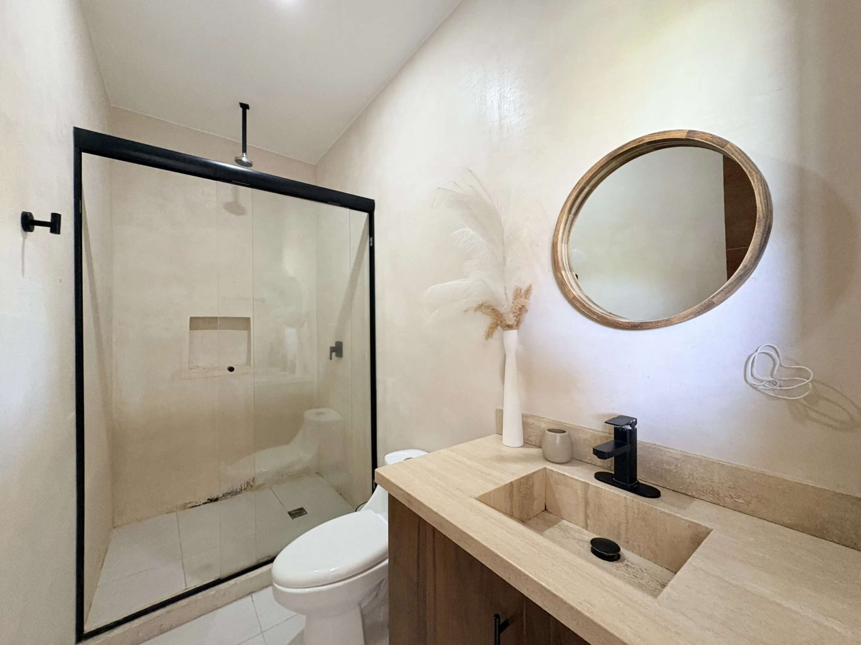 Beige bathroom with glass shower and vanity
