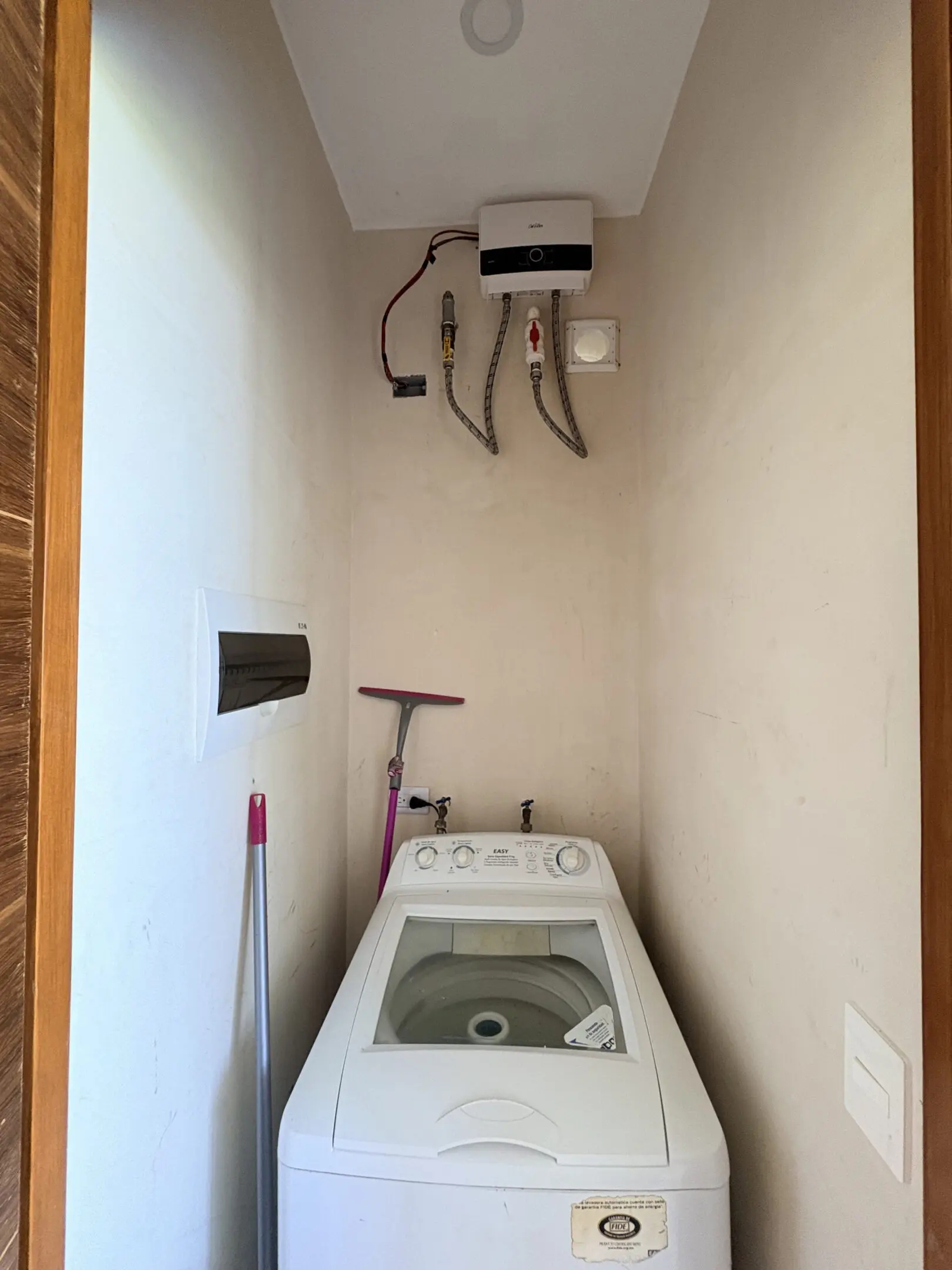 Top-load washer in narrow laundry closet with heater