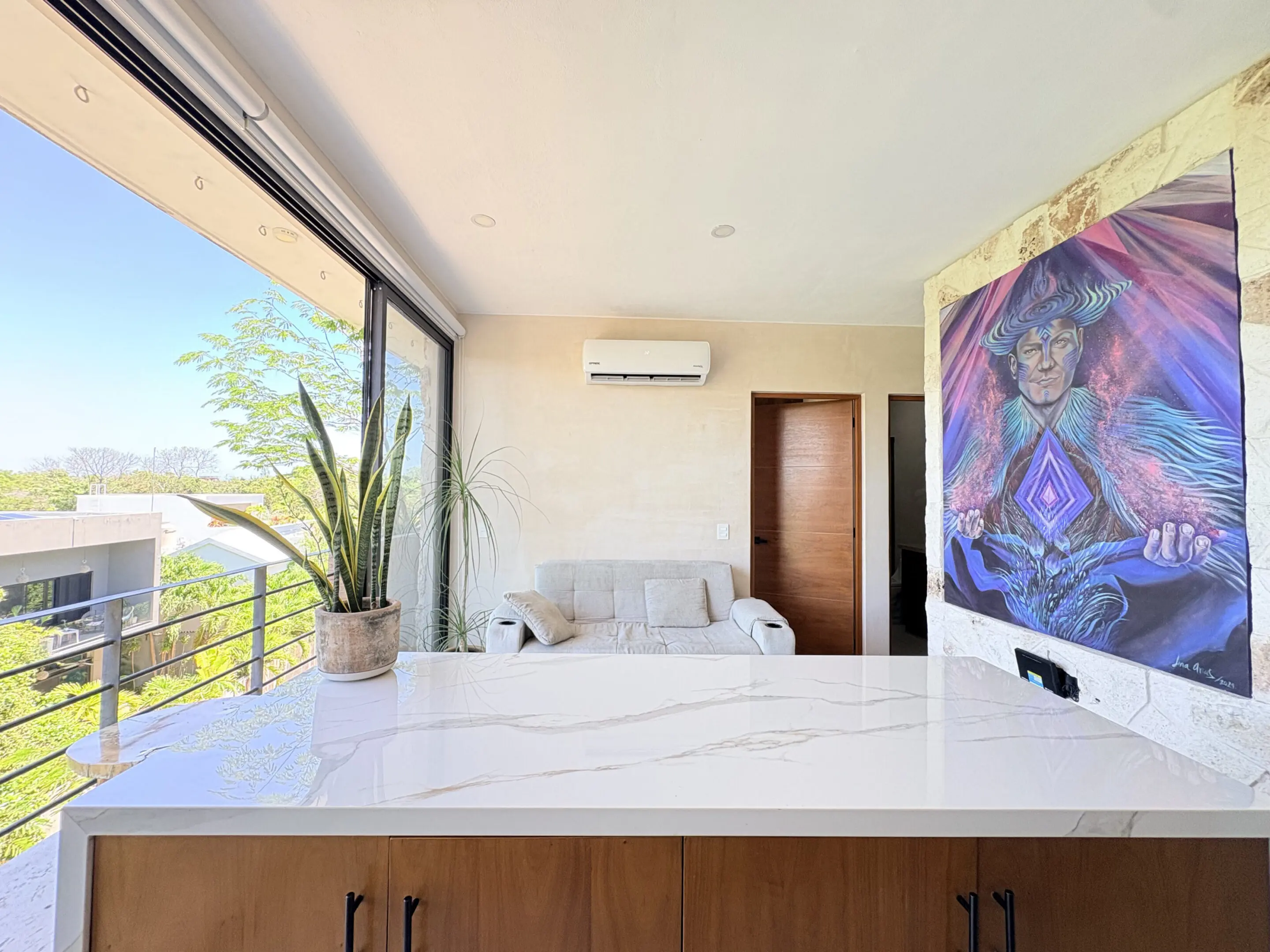 Bright living room with marble island and artwork
