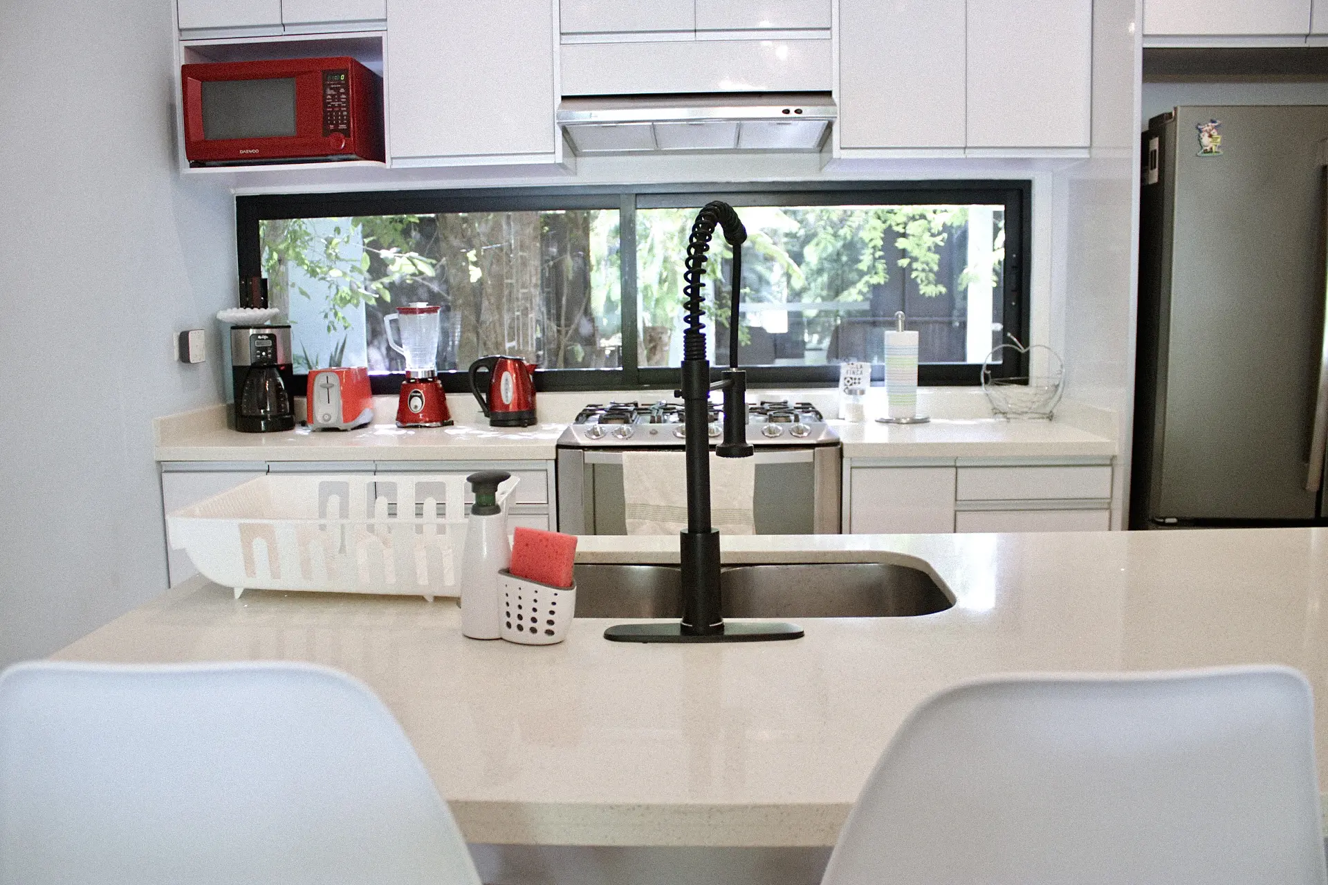 Modern kitchen island with black spring faucet