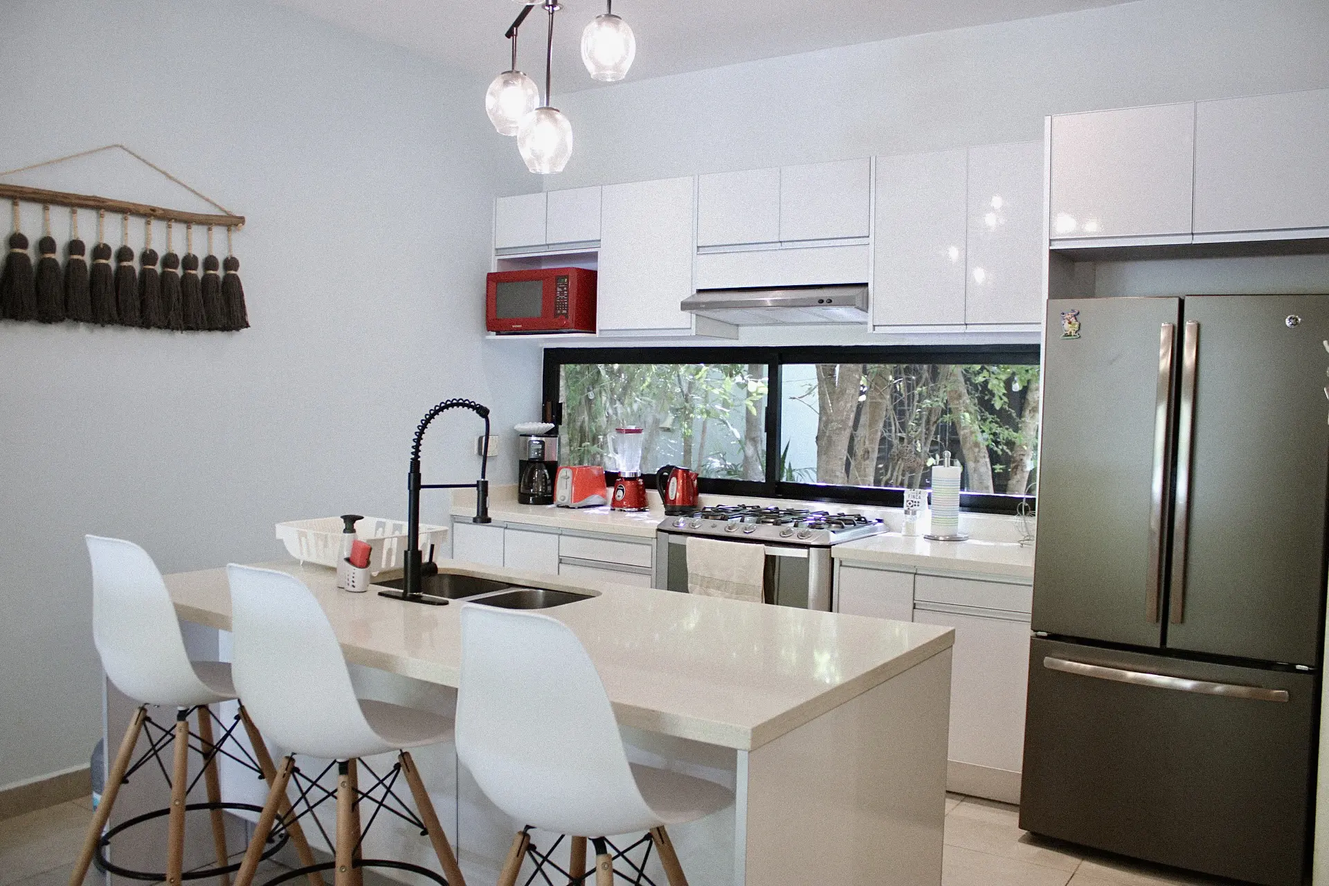 Modern white kitchen with island and stools