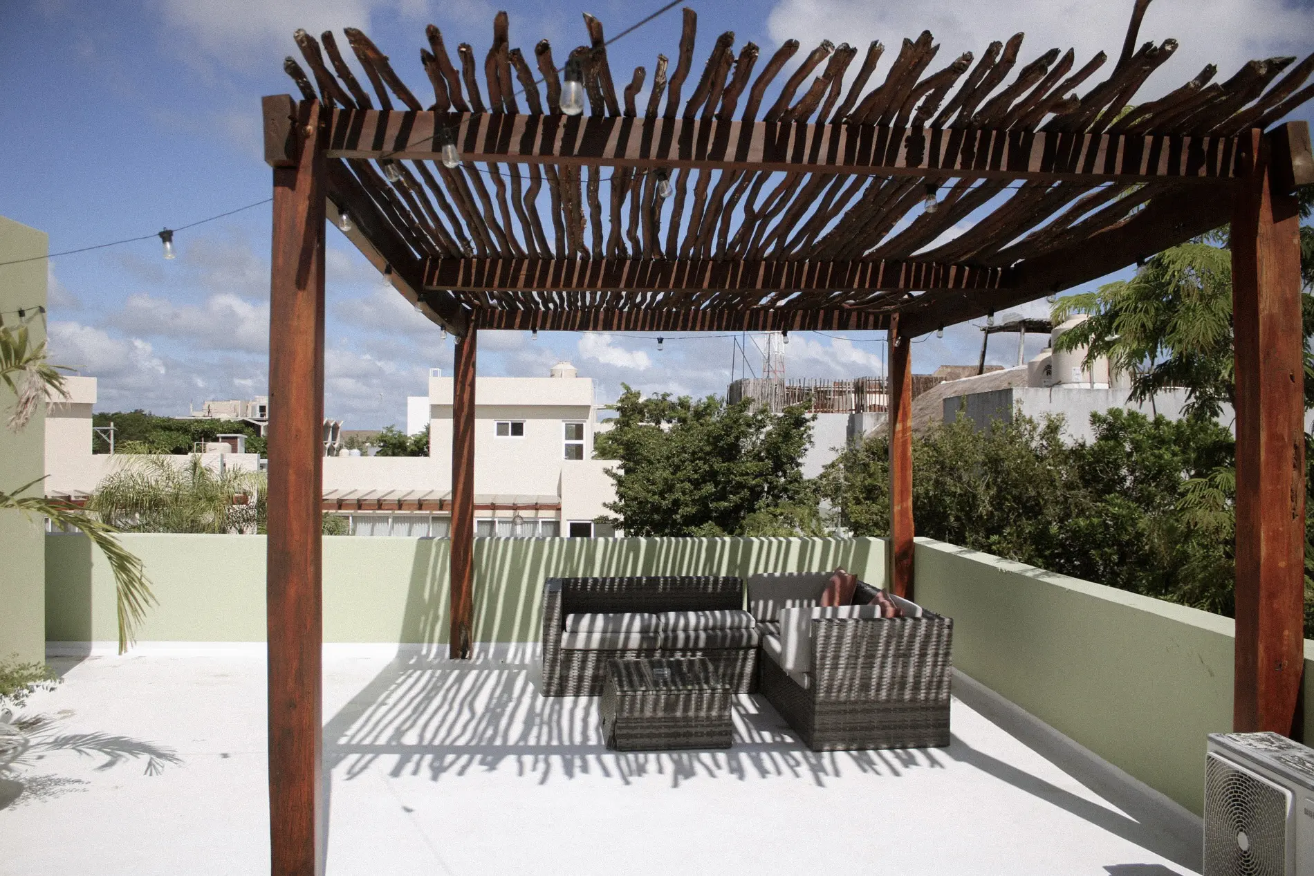 Rooftop terrace with wooden pergola and seating