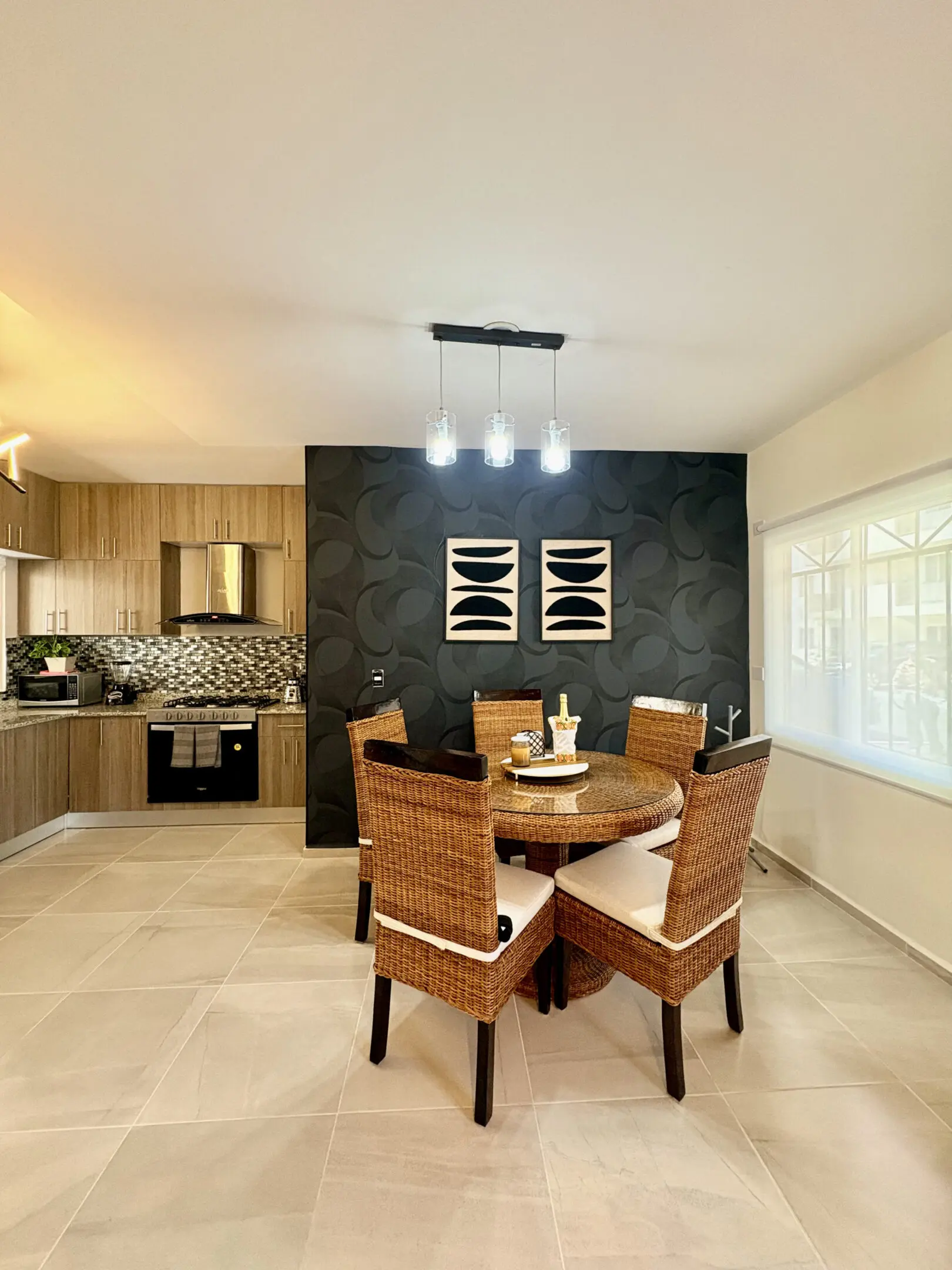 Modern dining area with wicker chairs and kitchen
