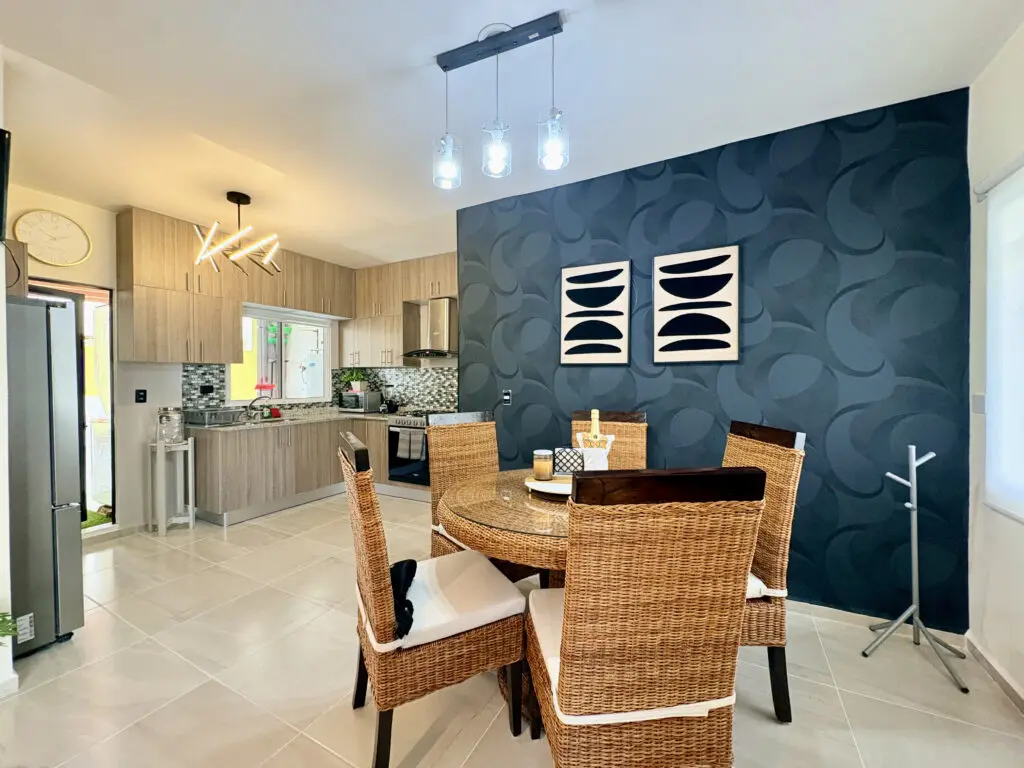 Open-plan kitchen and dining, round wicker table