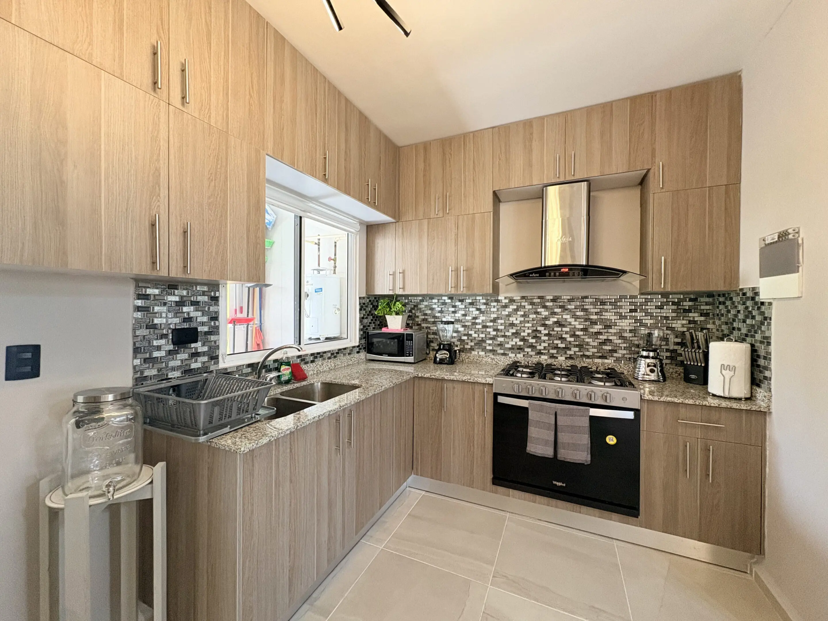 Modern L-shaped kitchen with stainless steel appliances